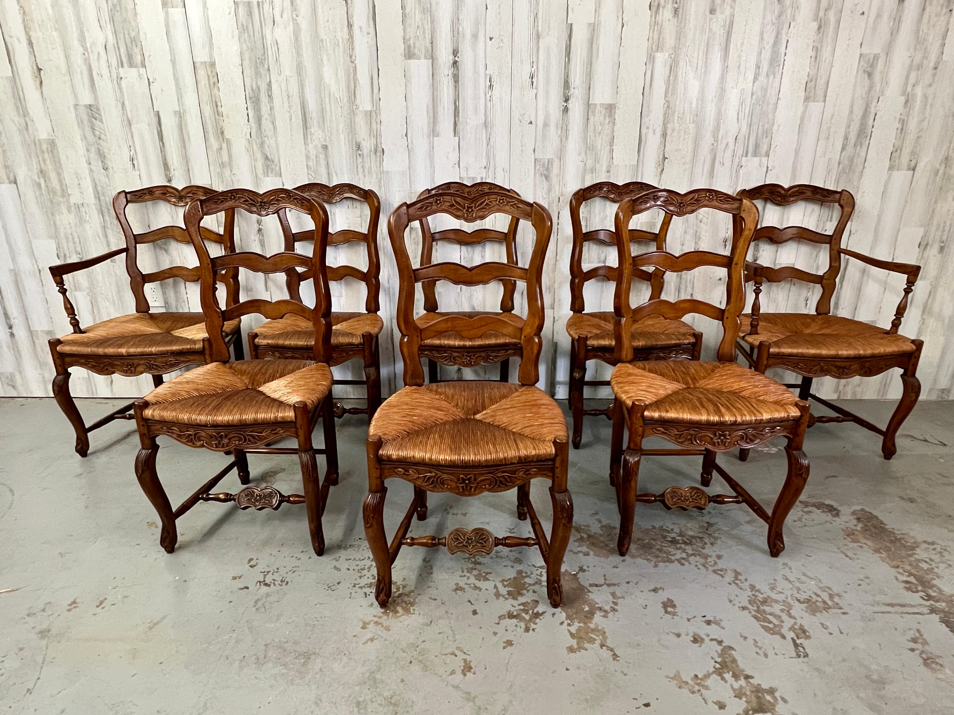 Very curvy and comfortable set of 8 country french farm chairs with real rush hand tied seats. Two arm chairs and six side chairs.
 Arm Chairs measure: 22.50 D x 23.50 W x 37.50 H x 17.50 Seat Height.
Side Chairs Measure: 19.50 D x 19 W x 38 H x