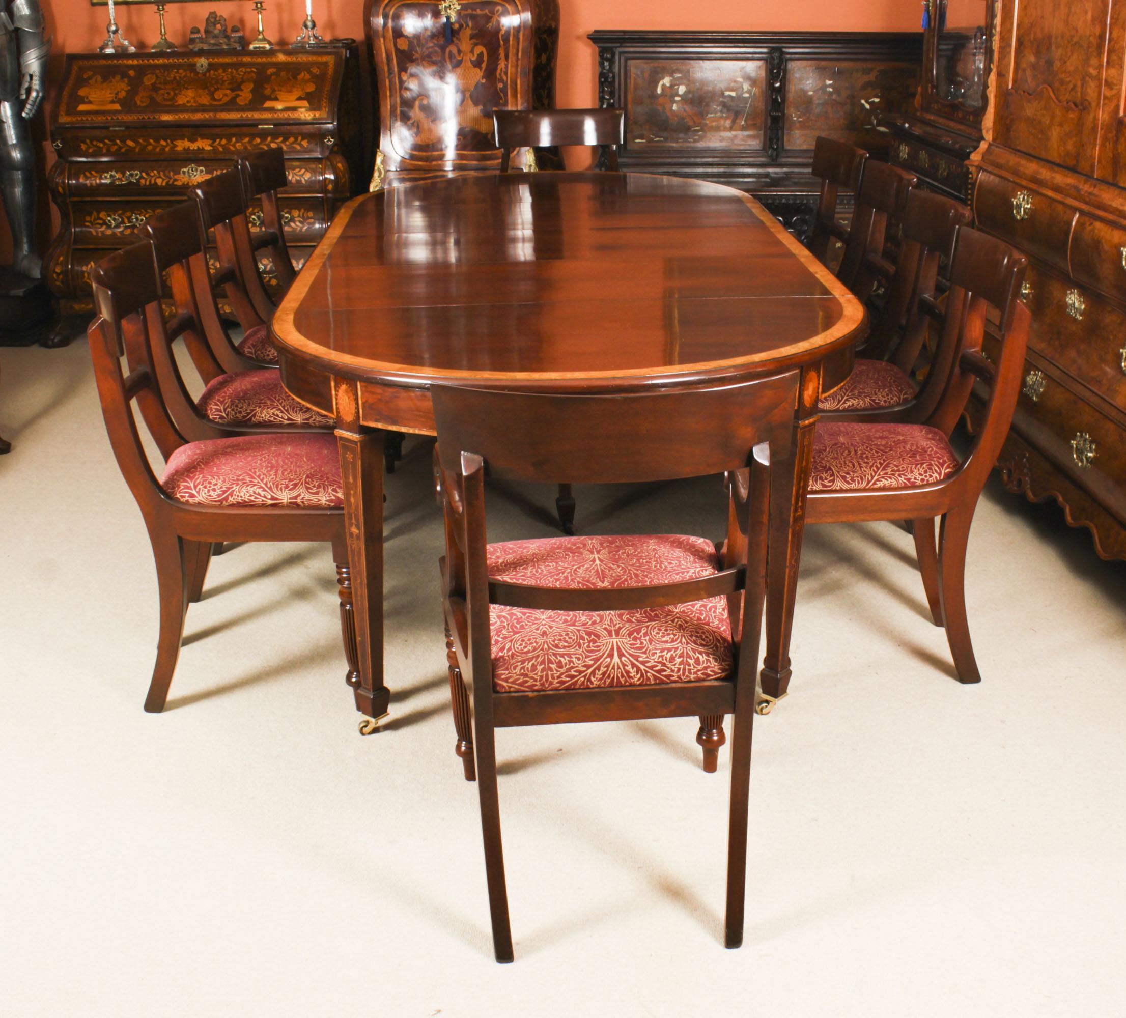 This is a fabulous dining set comprising an antique Edwardian inlaid flame mahogany extending dining table with an antique set of ten back dining chairs, 19th C in date.

The table has three original leaves and can comfortably seat ten. It has