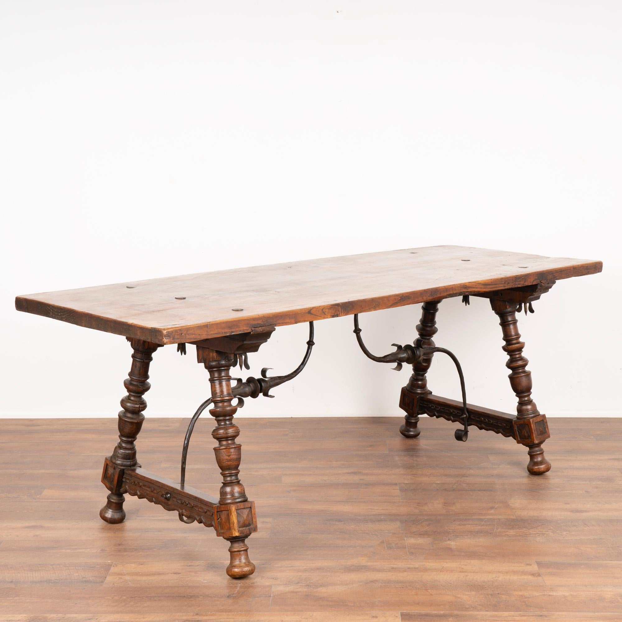 6.5' Oak dining table or writing desk from Spain with decorative turned legs and iron scrollwork stretcher.
Rich patina from generations of use.
Restored, strong and stable.
Please refer to professional photos to clearly understand color, finish,