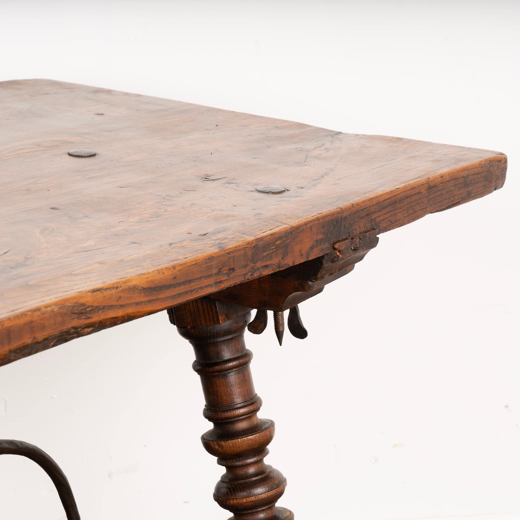 Spanish Antique Dining Table with Turned Legs and Scrolled Iron Stretcher from Spain