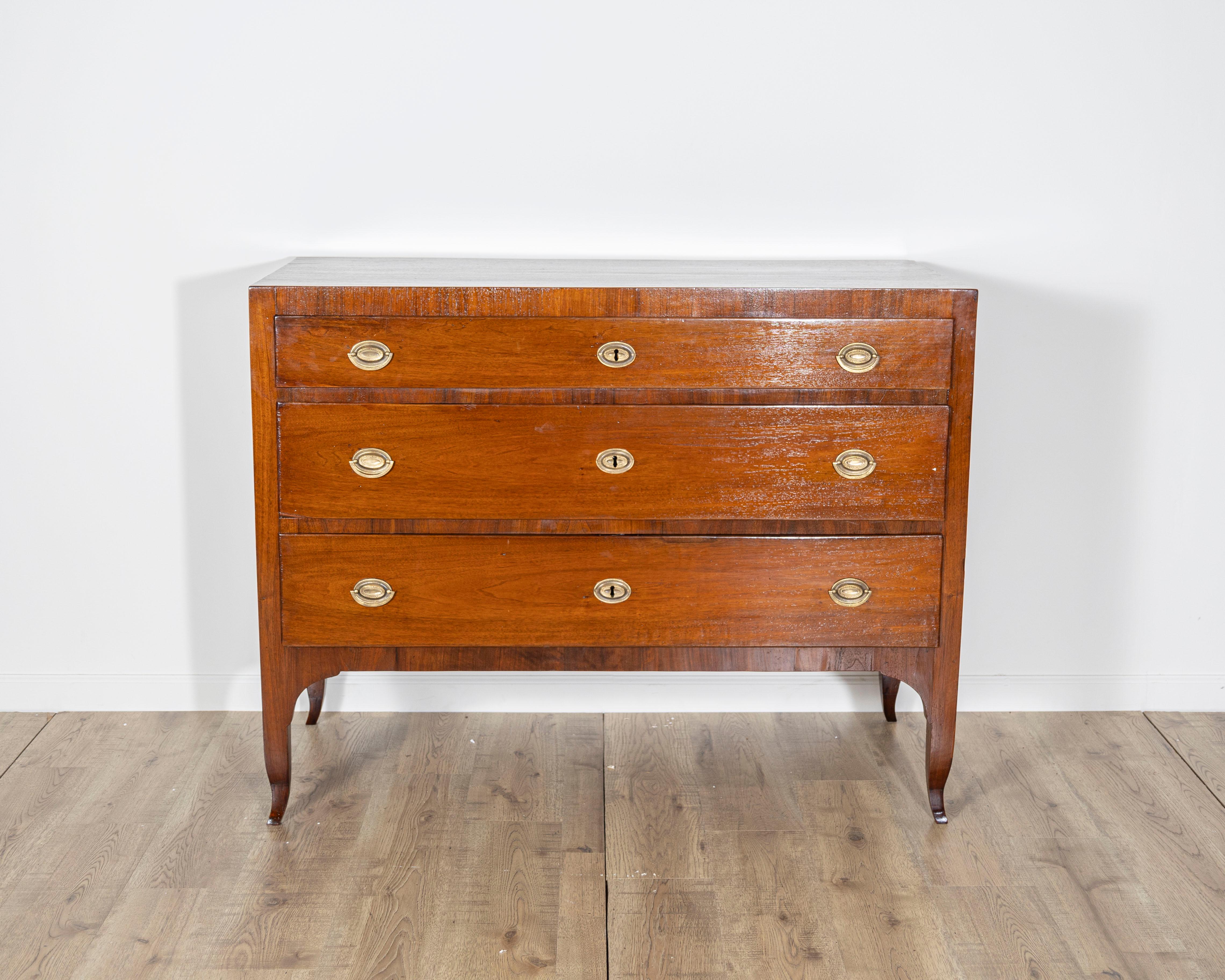 A refined example of Italian neoclassical furniture, this early 19th-century Directoire chest of drawers exudes timeless elegance and functionality. Originating in Italy and constructed from solid walnut, it showcases the restrained architectural