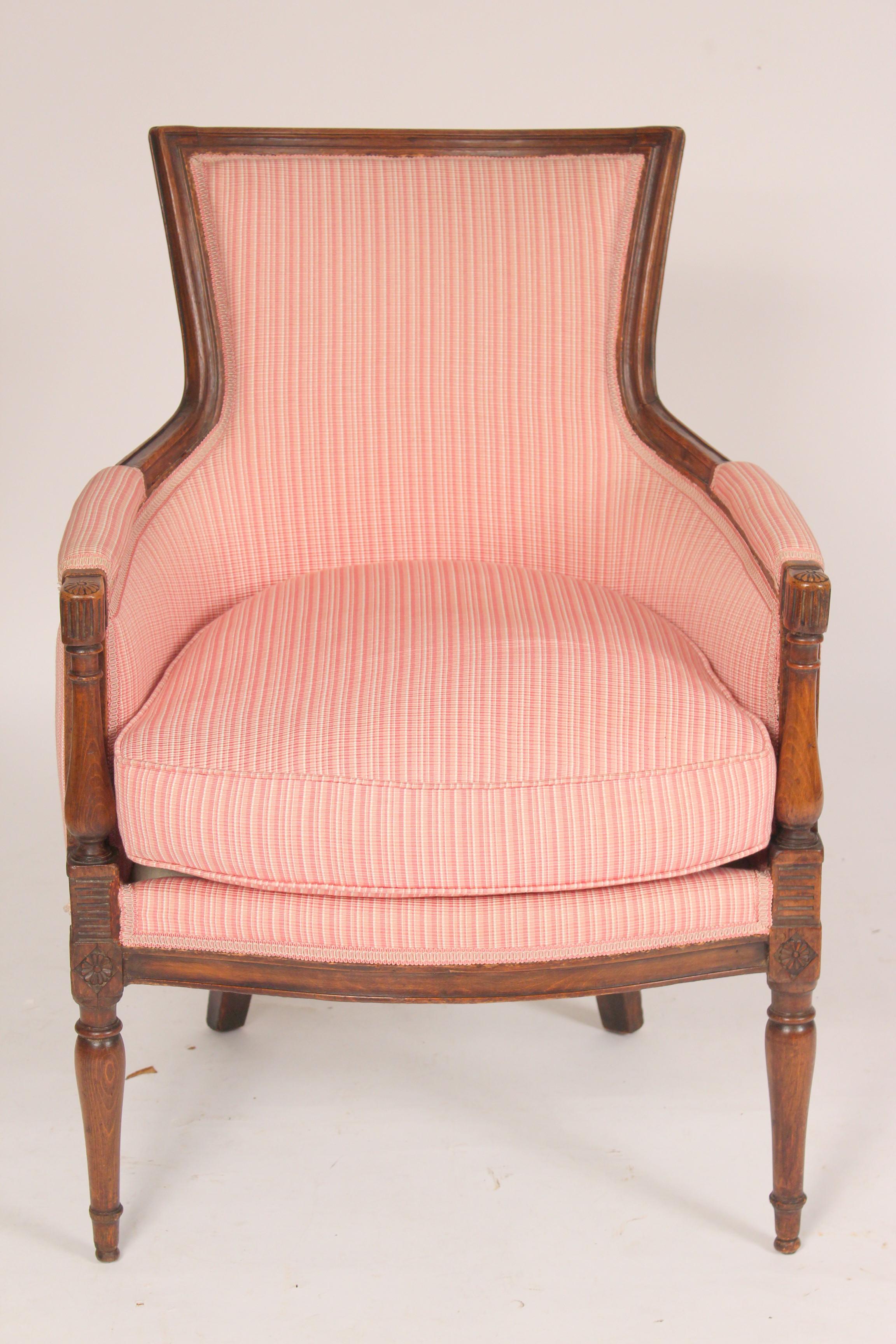 Antique Directoire style beech wood bergère, 19th century. The wood has nice old color, upholstery is in very good condition, recently reupholstered. Seat depth of 20