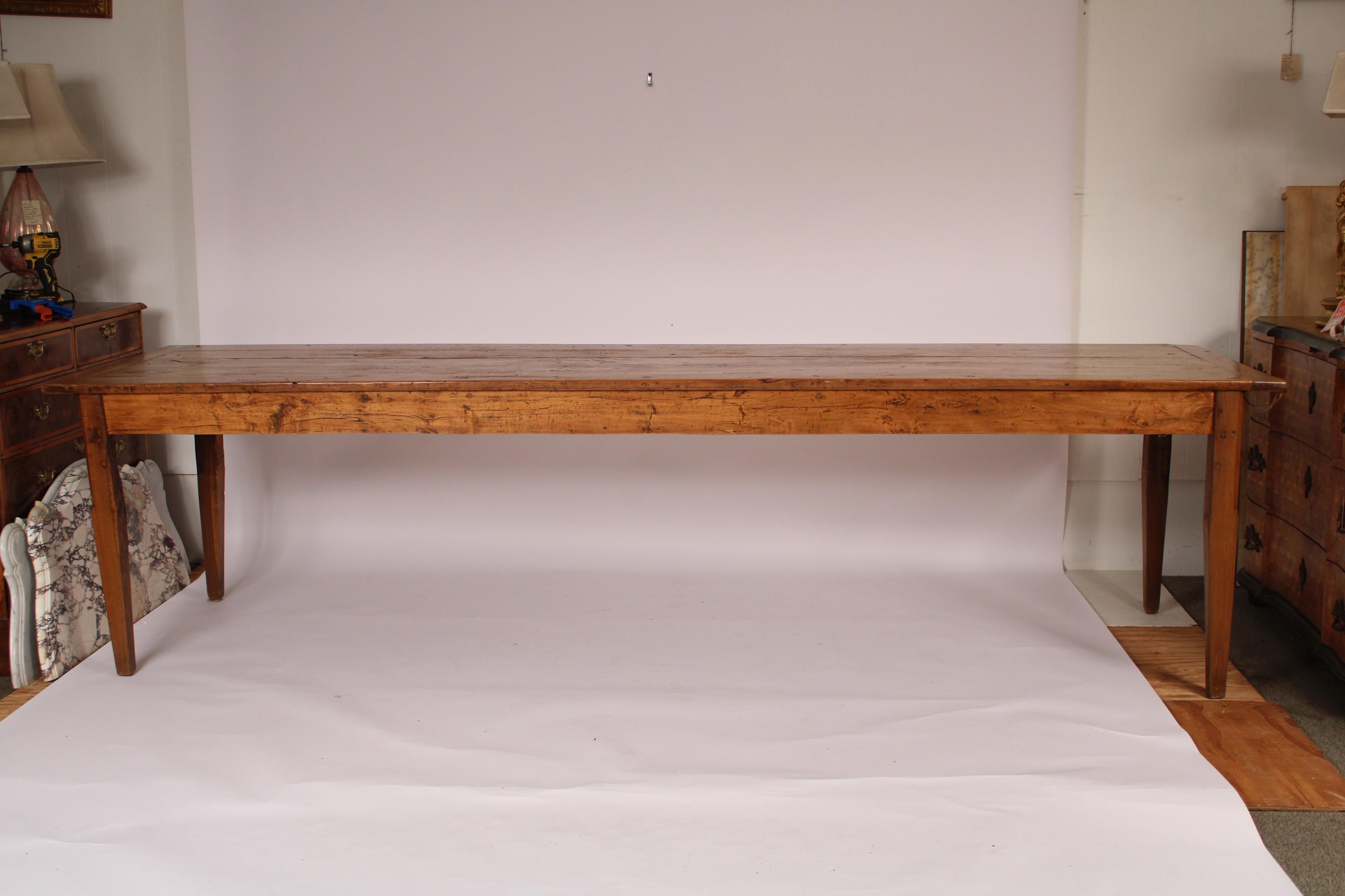 Antique Directoire style fruitwood dining room table, late 19th century. With a 6-board plank top, drawer at each end of the table resting on square tapered legs. Knee clearance 25