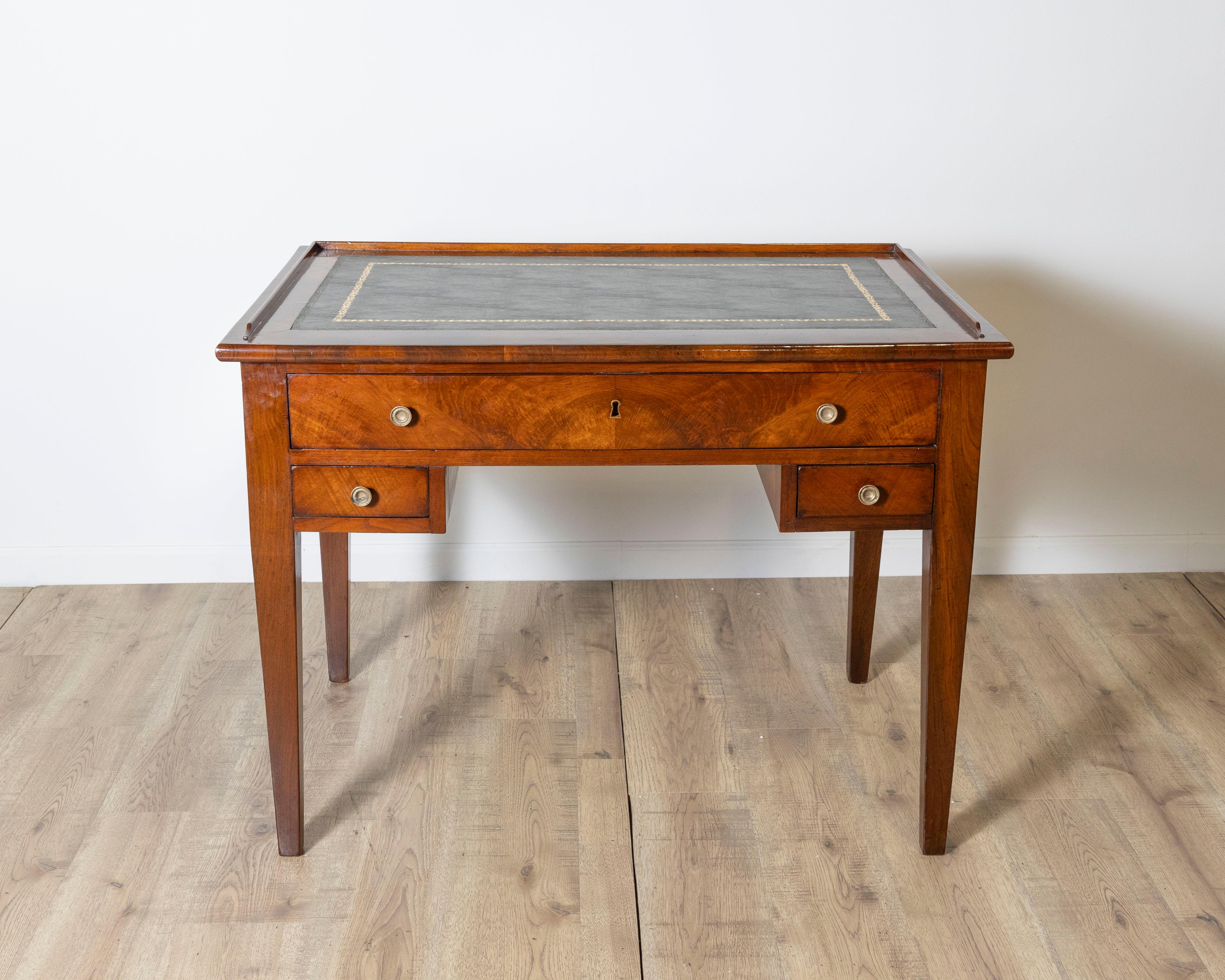 This refined Italian Directoire writing desk, dating to the early 19th century, showcases the minimalist elegance and architectural precision associated with the Directoire period. 
Masterfully crafted in solid walnut, the desk features a
