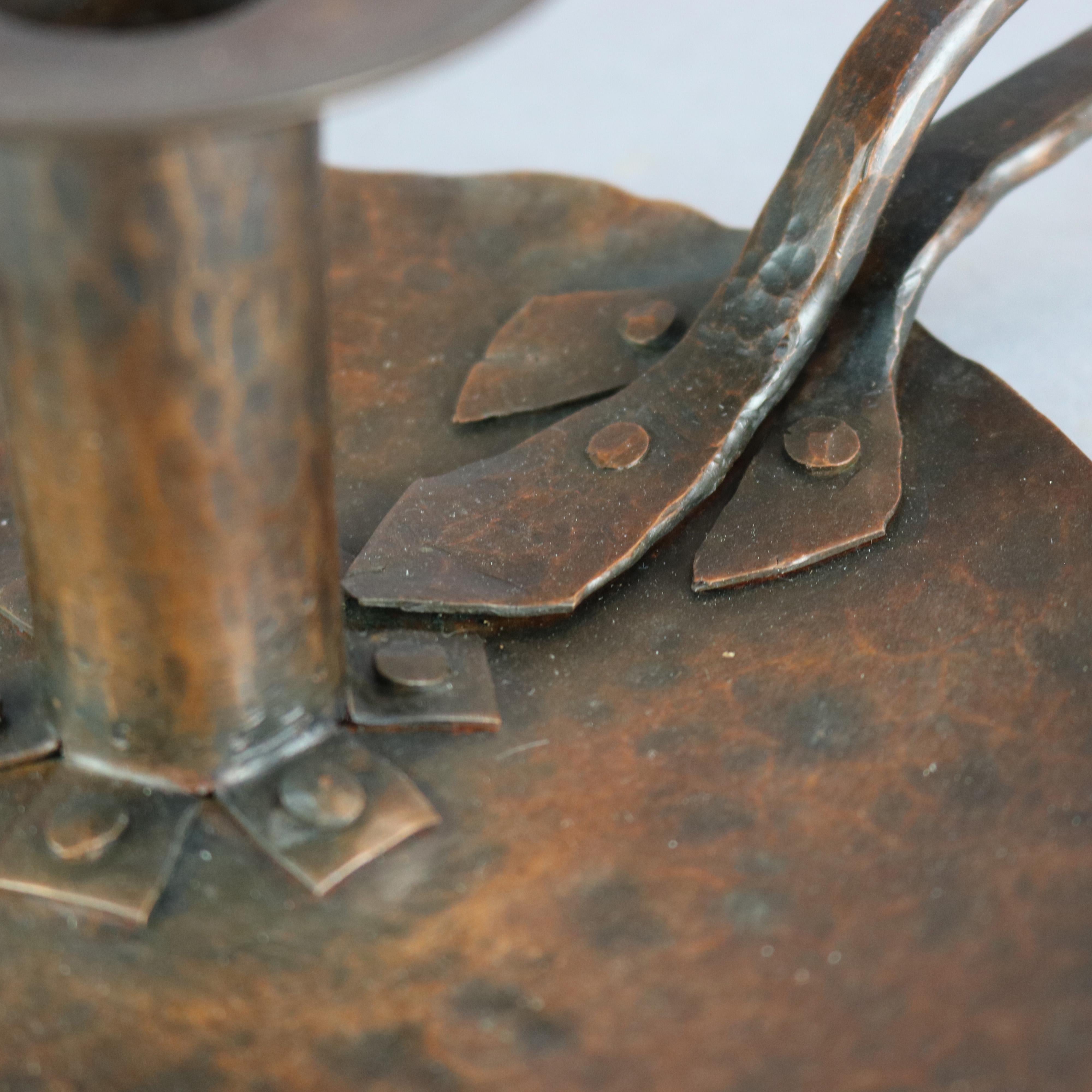 An antique chamber candlestick in the manner of Dirk Van Erp offers hand hammered copper construction with base having well and finger hold, en verso later added windmill stamp as photographed, 20th century.

Measures: 5