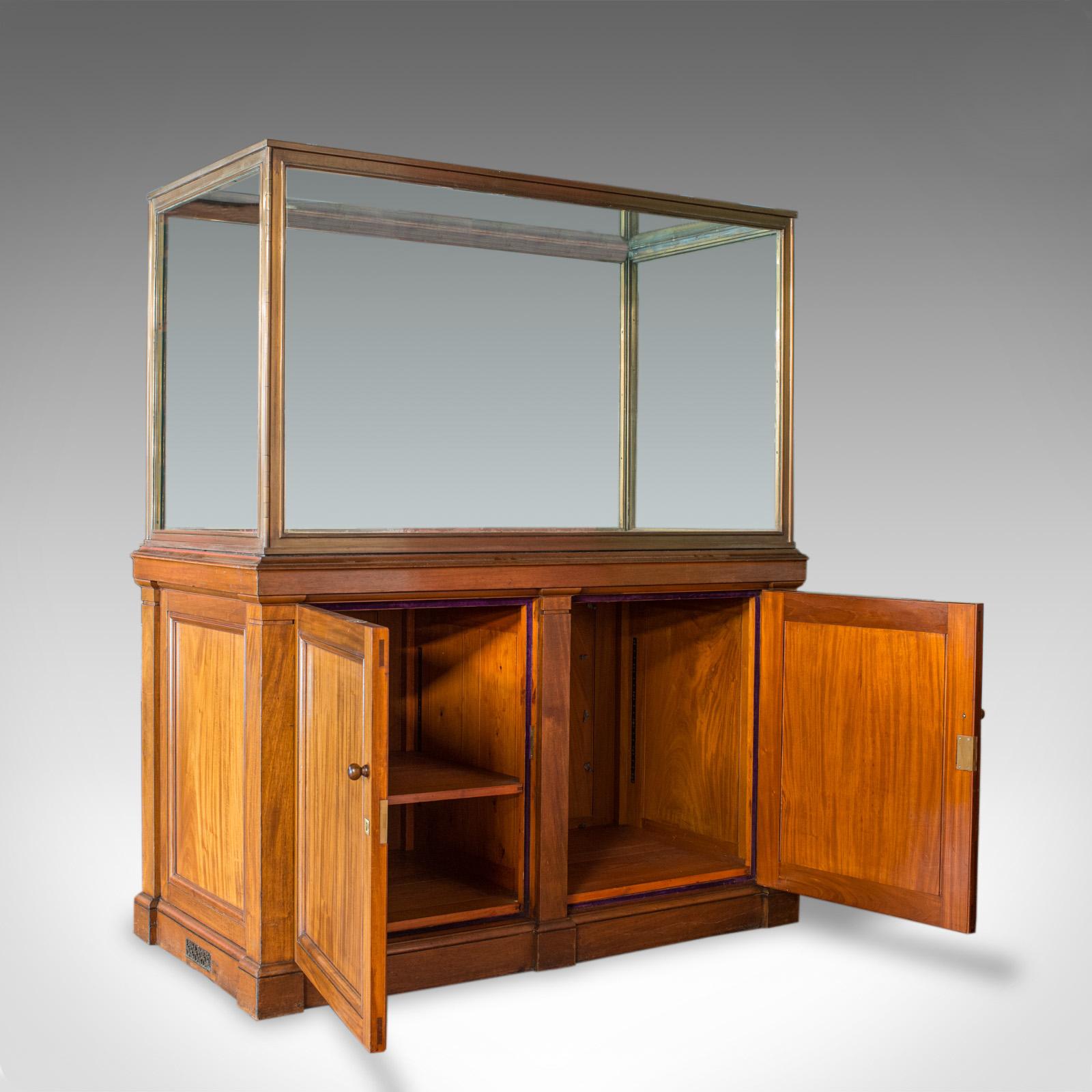 This is an antique display cabinet. An English, walnut and bronze showcase of museum quality and dating to the late 19th century, circa 1900.

Generous proportion and with a desirable aged patina
Select walnut displays fine grain interest and rich