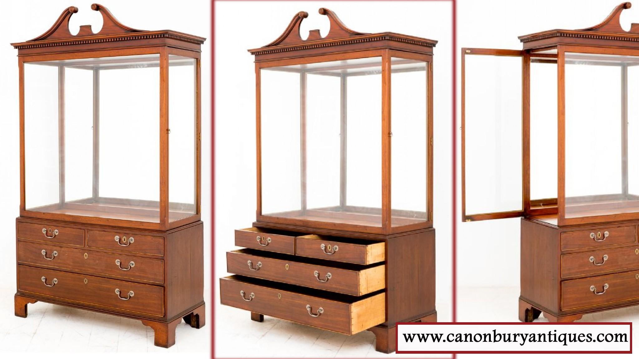 A Lovely Mahogany display cabinet with Georgian elements.
Standing on Bracket feet with an arrangement of 2 over 2 Oak lined drawers.
The top section with 2 x opening doors and a parquet floor and mirrored back.
The dentil cornice adorned with a