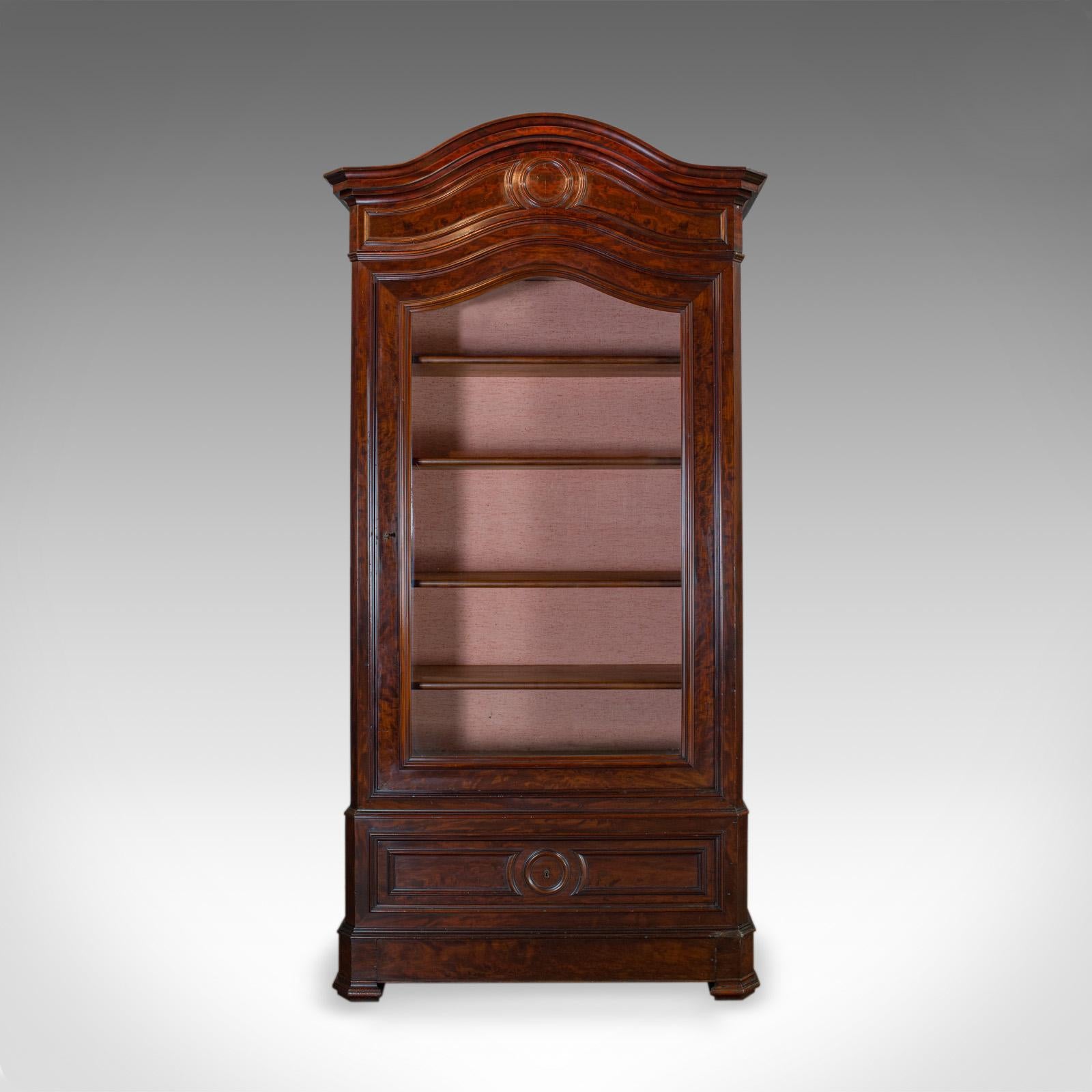 This is an antique display cabinet. An English, Victorian, flame mahogany vitrine dating to the mid-19th century, circa 1850.

Magnificent Victorian vitrine
Deep russet tones to the select flame mahogany
Grain interest and a desirable aged