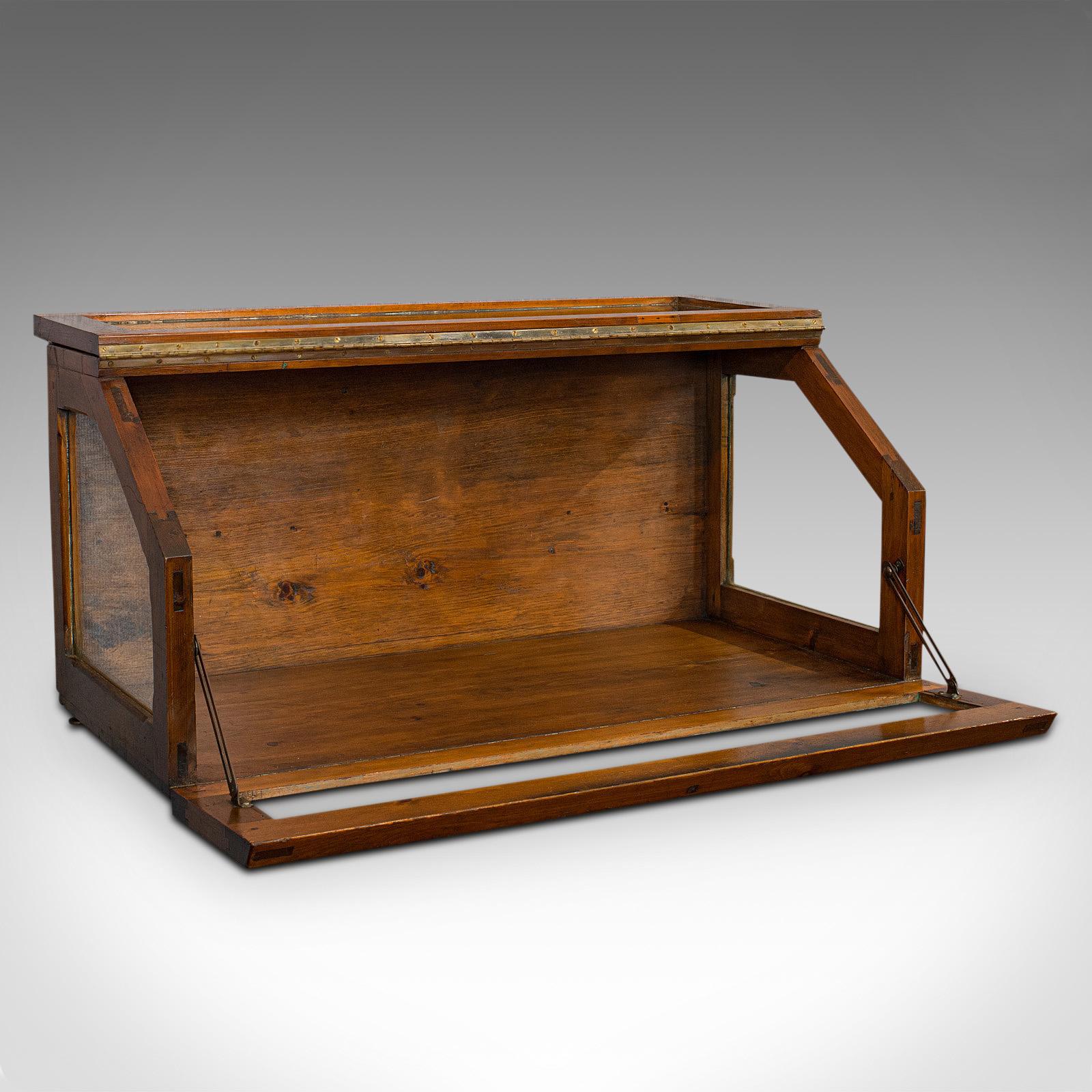 This is an antique display case. An English, pitch pine haberdashery retail counter top cabinet, dating to the Edwardian period, circa 1910. 

Quality Edwardian shop cabinet
Displays a desirable aged patina
Pitch pine shows fine grain