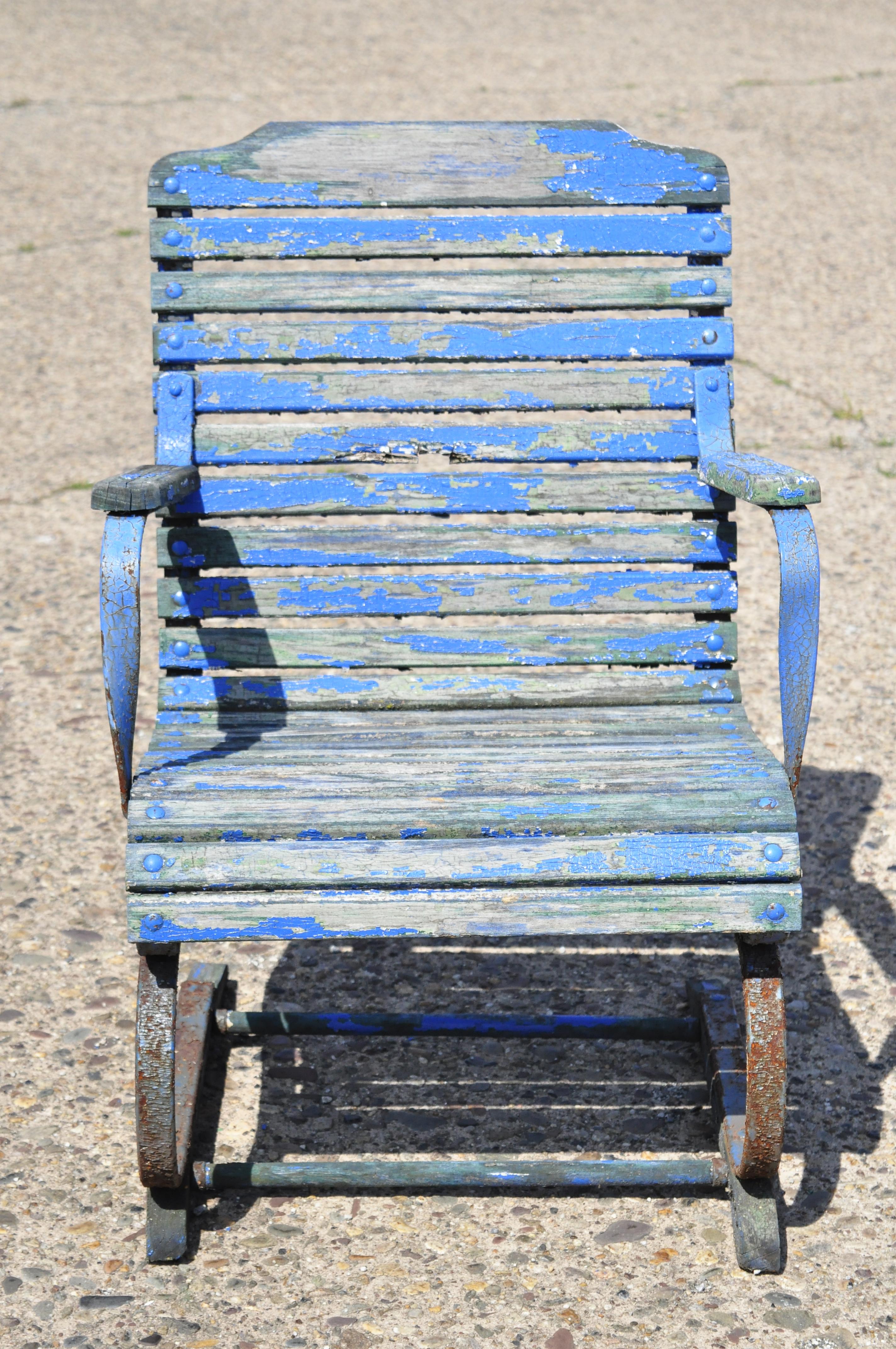 Antique distressed blue painted wooden slat wrought iron frame Art Deco bouncer chair. Item features wooden slats, wrought iron bouncer frame with wooden runners, distressed finish, very nice antique item. Circa early to mid 1900s. Measurements: