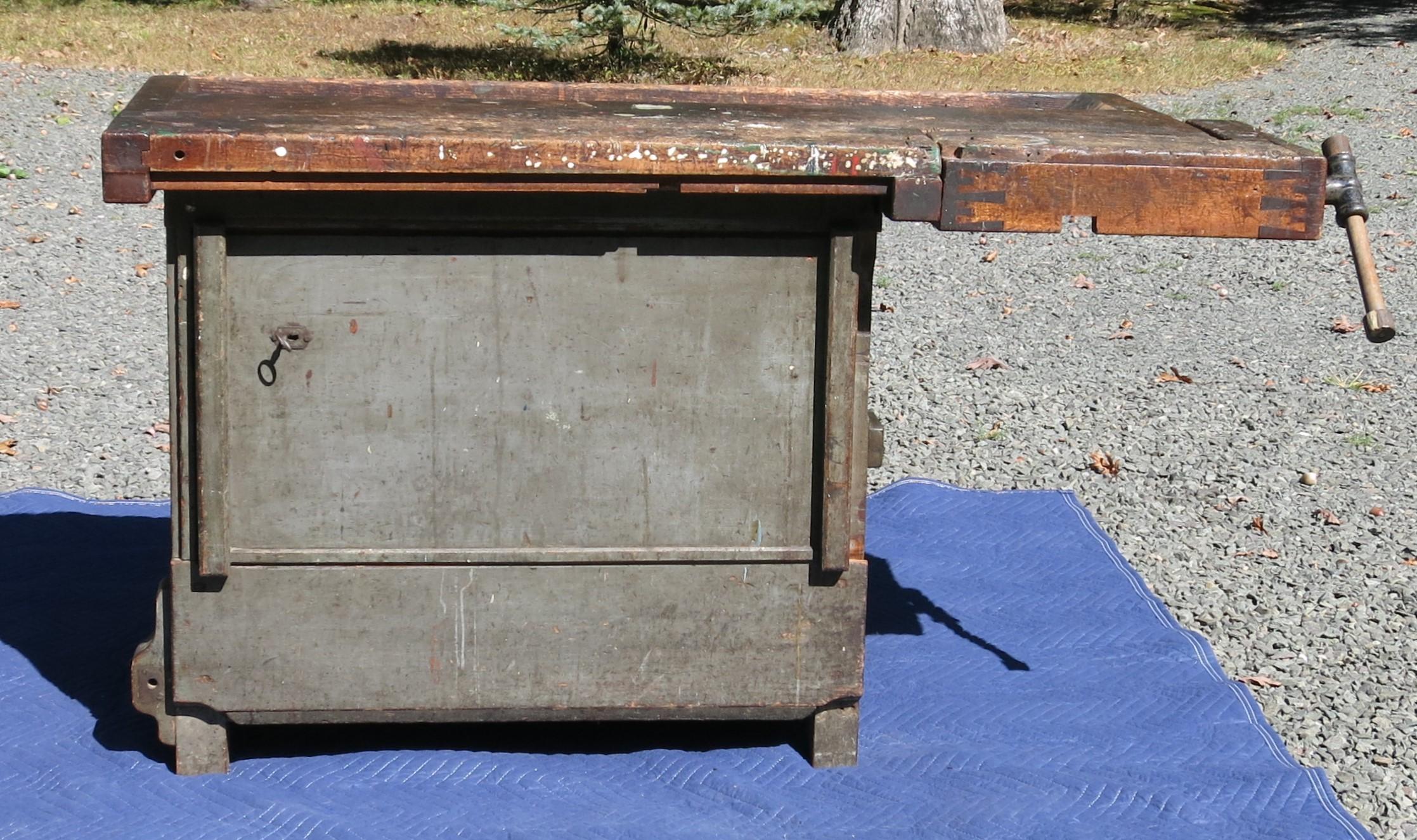 Antique distressed carpenters workbench with vise. It is 55