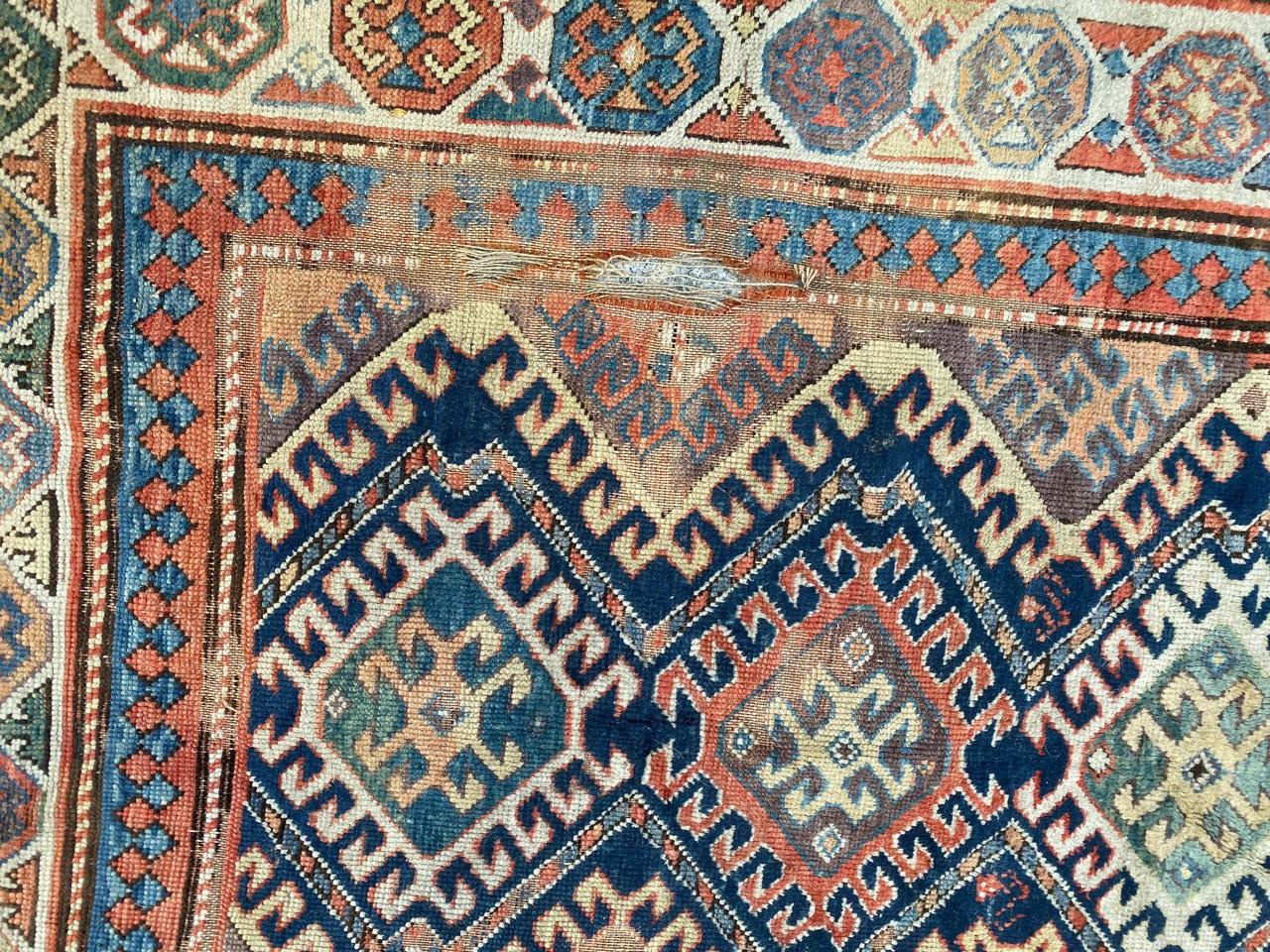 Kazakhstani Antique Distressed Caucasian Kazak Rug