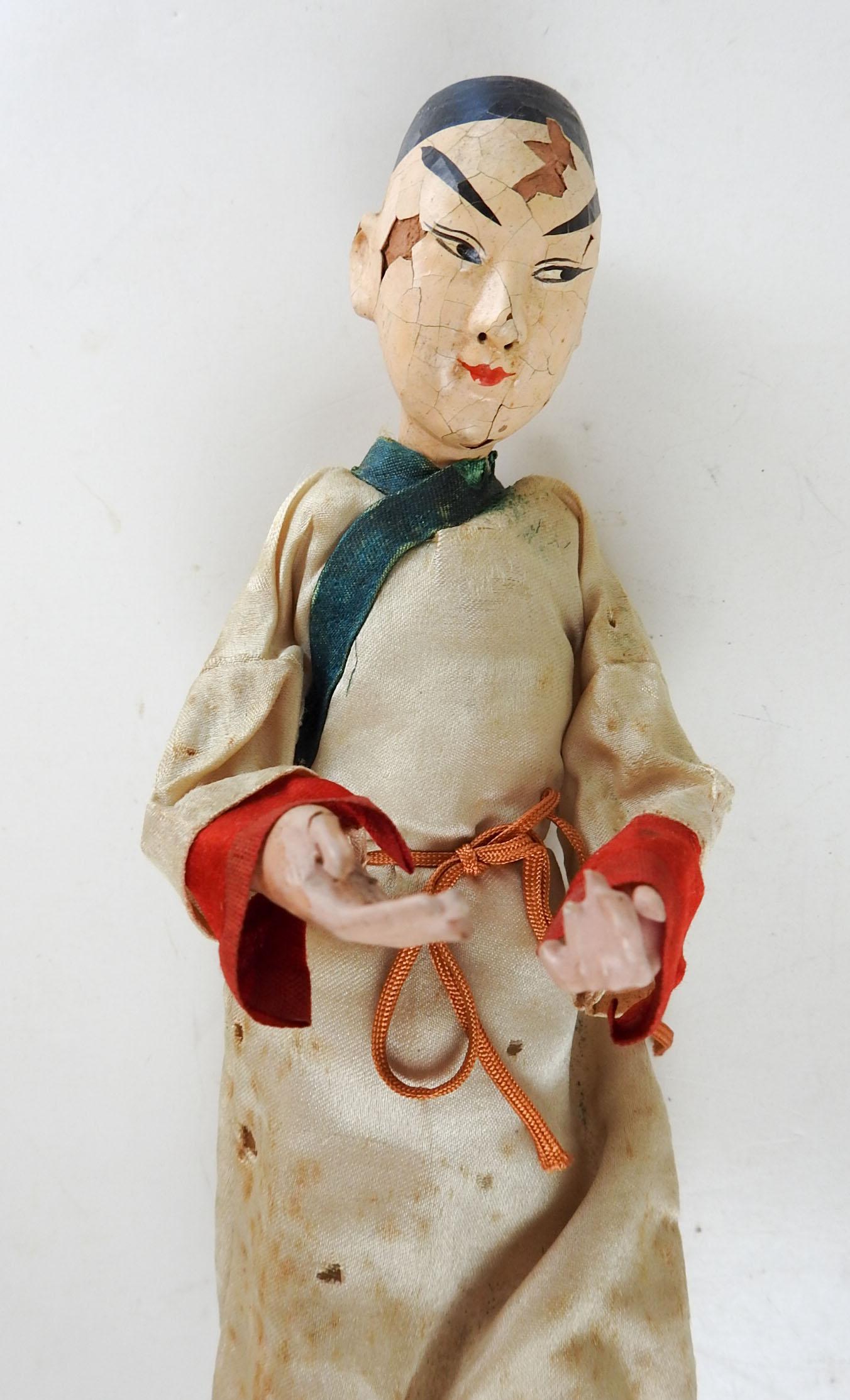 Antique Chinese opera doll. Plain silk robe, wire stand attached to shoes. Wire armature, composition or paper mache head, hands and feet, 9