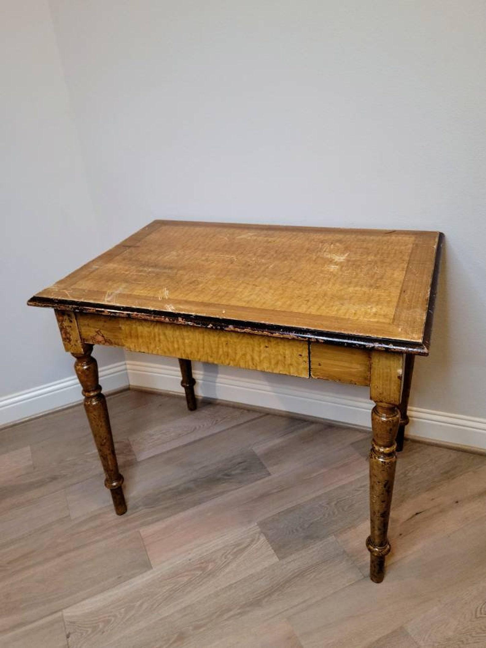 A heavily worn and distressed hand painted yellow faux wood grain farmhouse kitchen work table. 

Hand-crafted of solid wood, richly detailed original antique character including faux cross-banded faux graining framed highly figured quilted maple