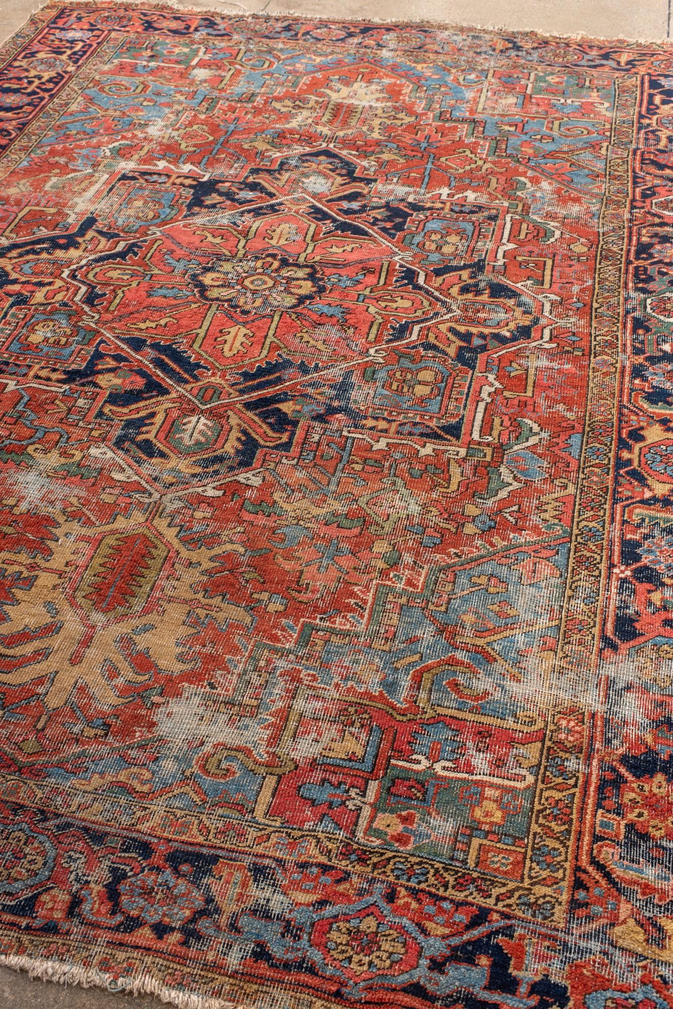 Persian Antique Distressed Heriz Rug with Bold Medallion For Sale