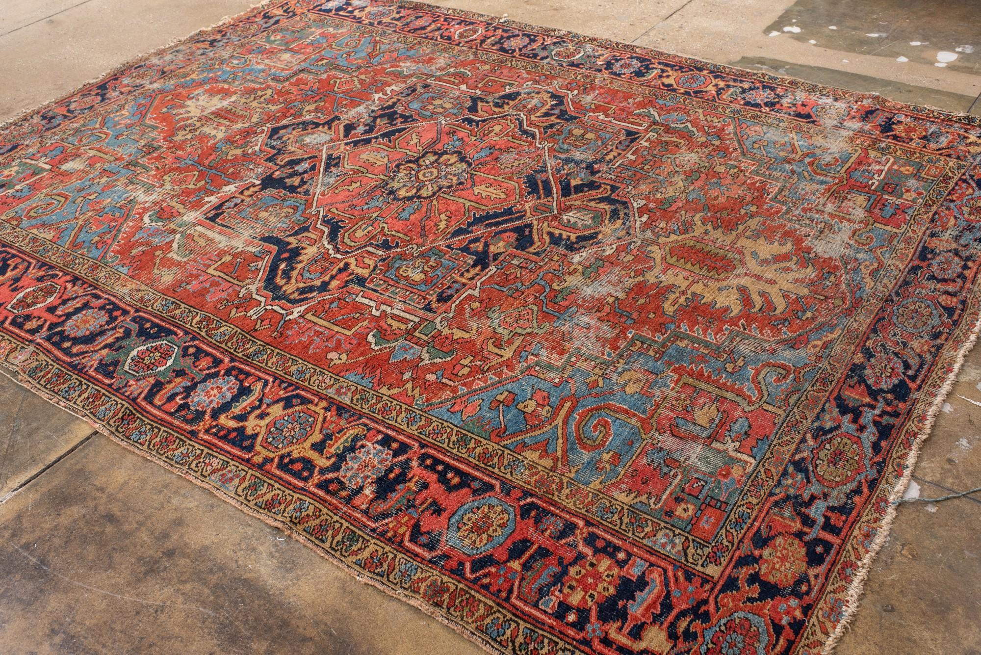 20th Century Antique Distressed Heriz Rug with Bold Medallion For Sale