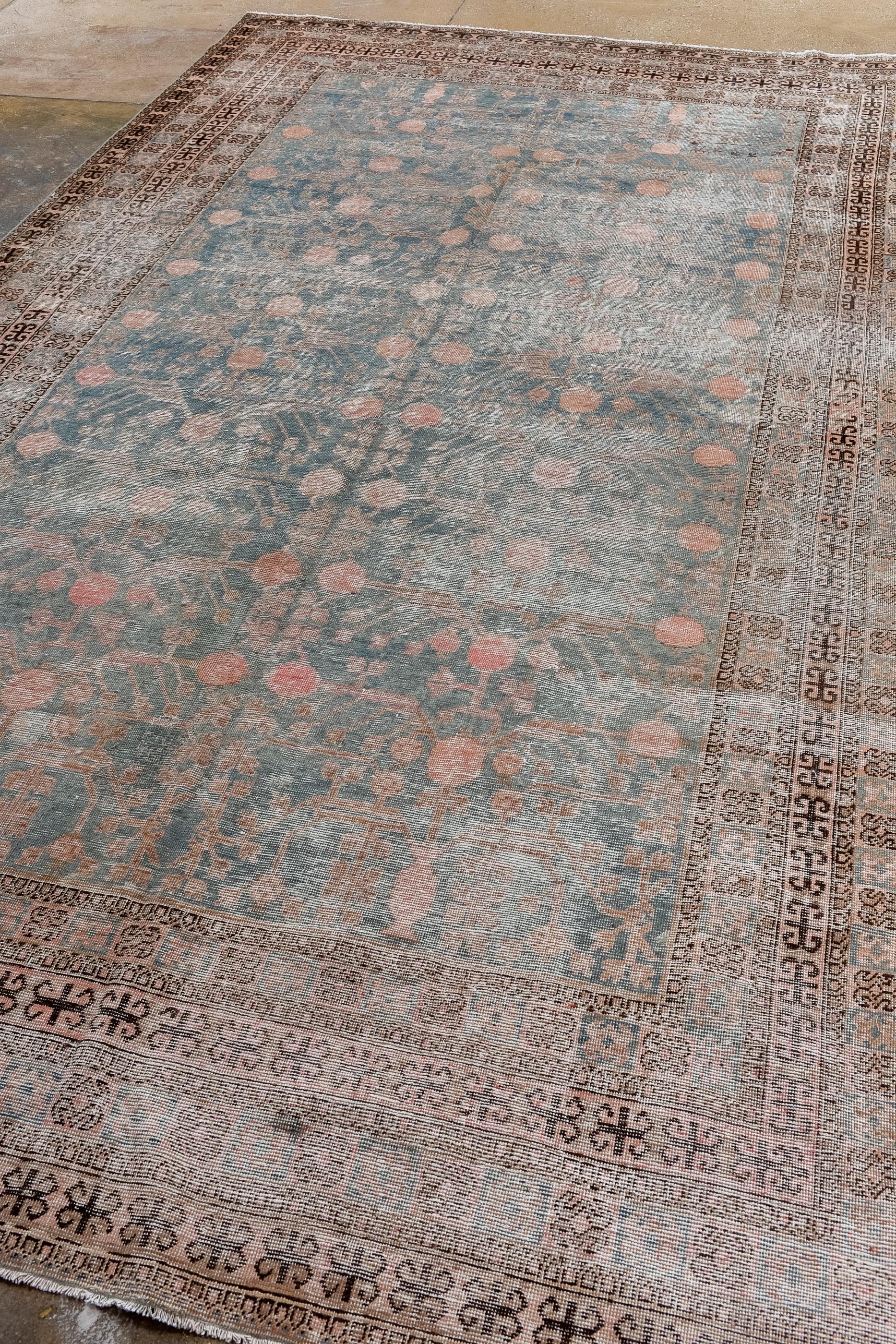 Persian Antique Distressed Khotan Rug with Pomegranate Trees  For Sale