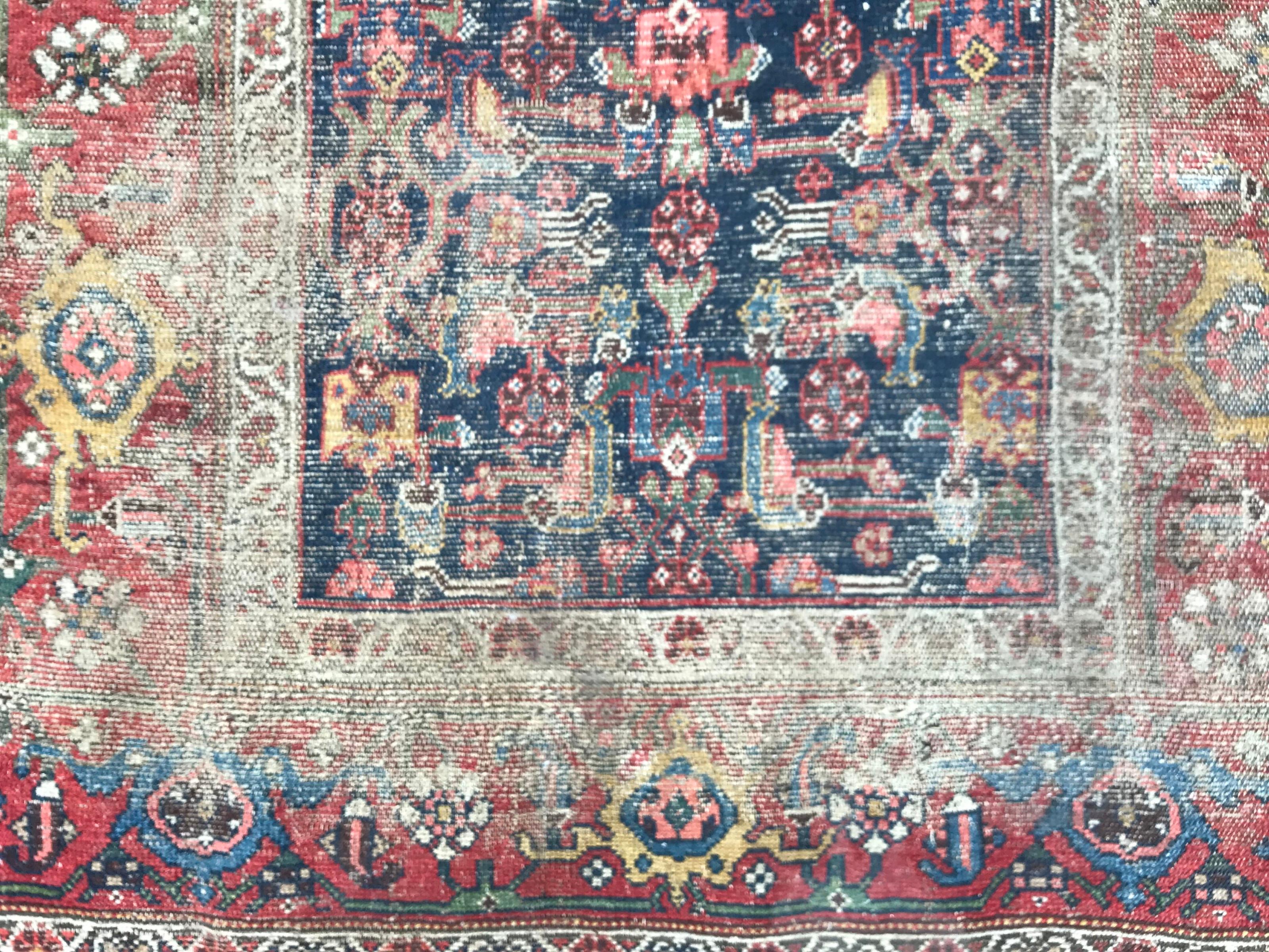 Distressed 19th century rug with nice design and natural colors, entirely hand knotted with wool velvet on wool foundation.