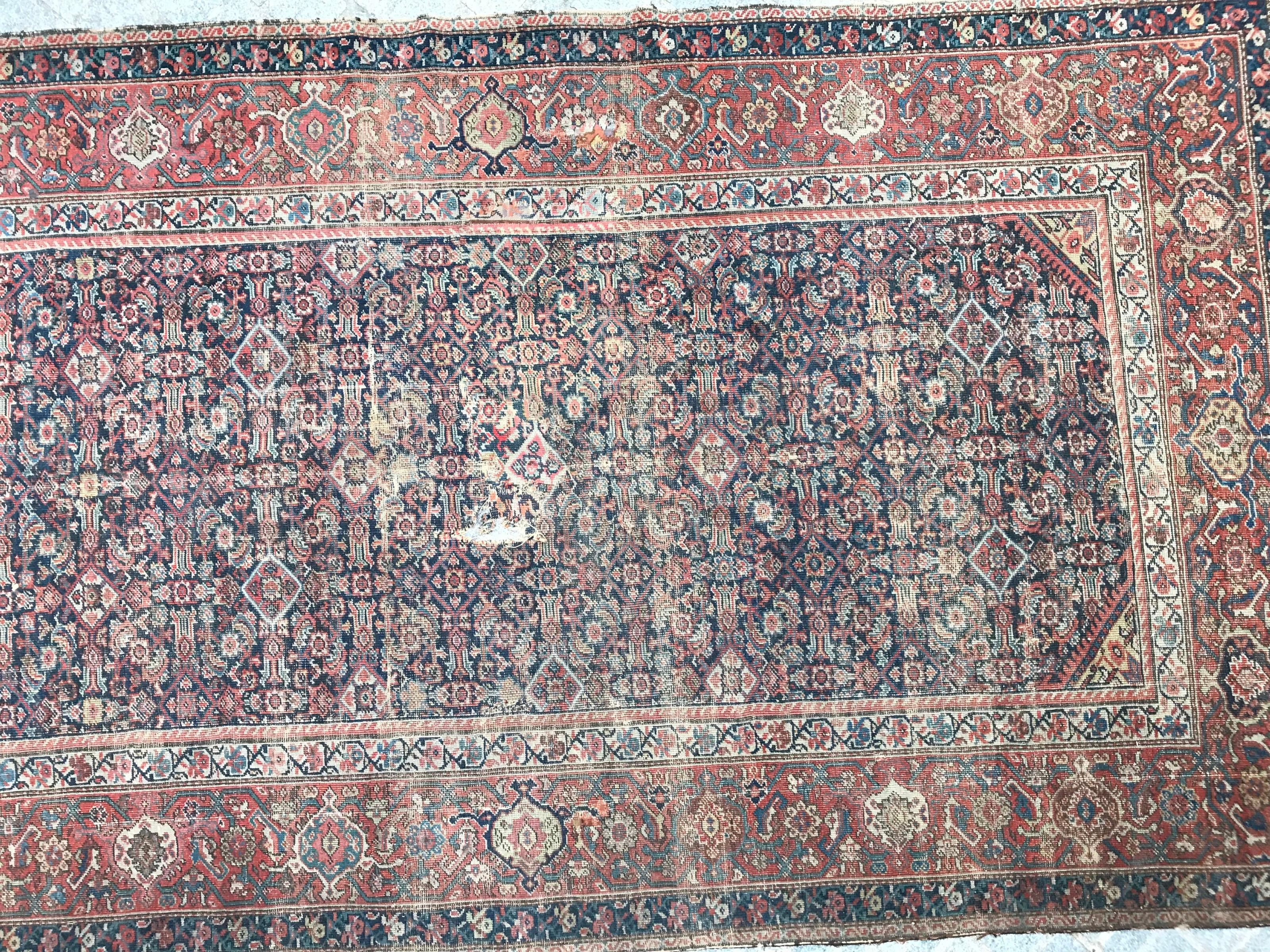 Beautiful late 19th century long rug with a decorative Herati design and natural colors with dark blue, red, green and yellow colors, entirely hand knotted with wool velvet on cotton foundation.