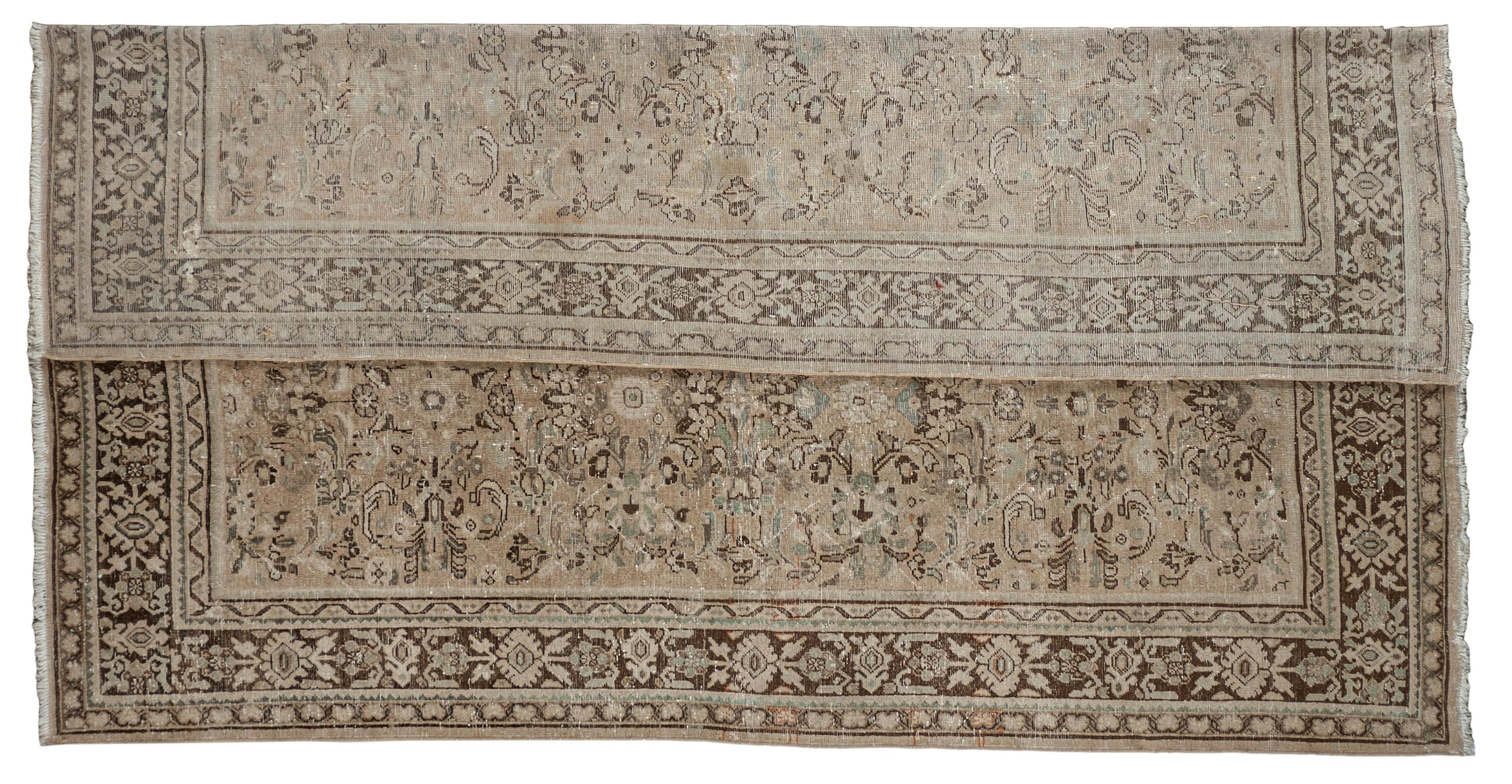 This antique distressed Mahal is an all wool handmade and hand knotted rug. It has an all over design from the 20th century and was made in Iran. The name is derived from the Mahallat village where the rugs were crafted, and they are characterized
