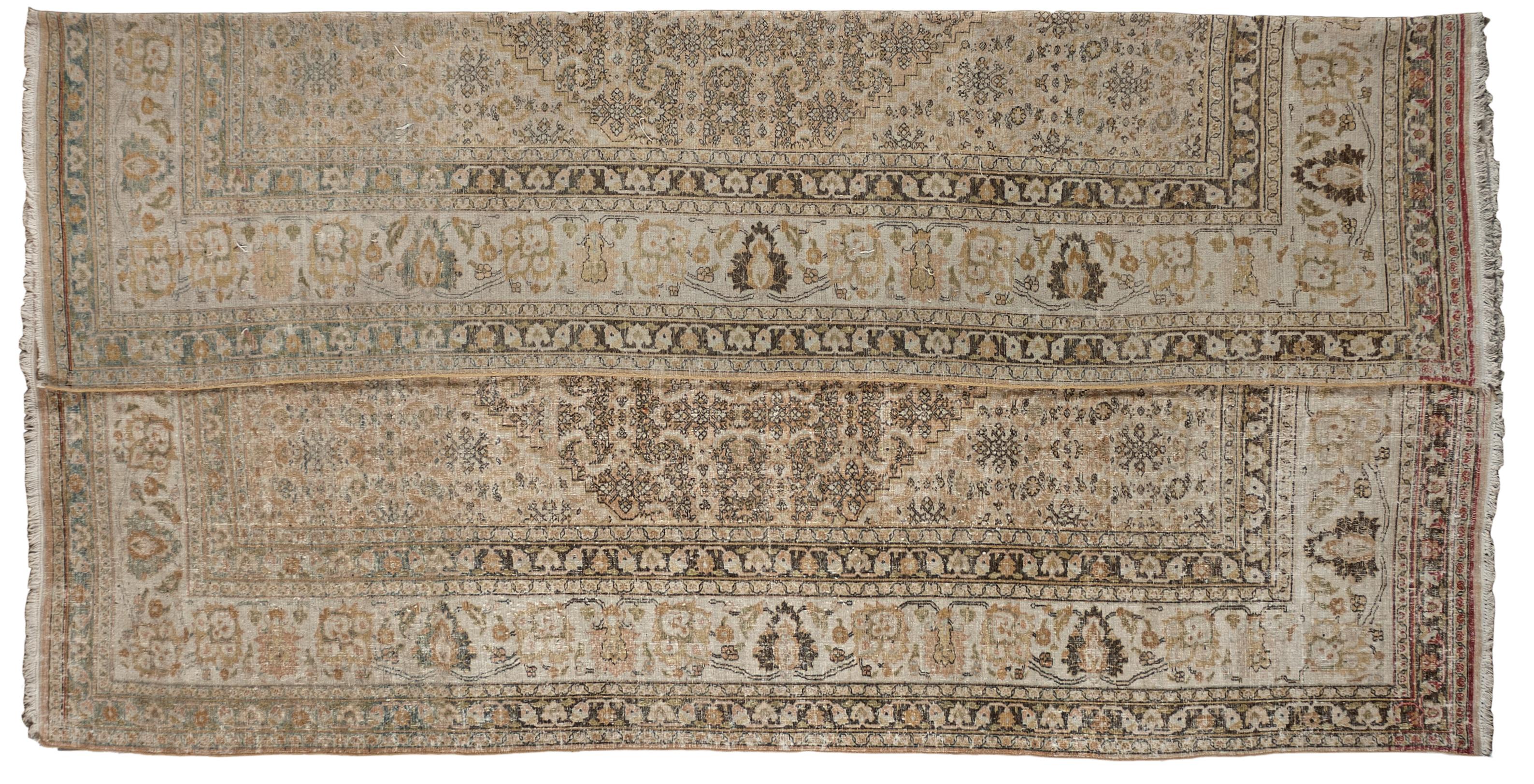 This antique distressed Mahal is an all wool handmade and hand knotted rug. This distinctive area rug that has a center medallion and wide stylized floral frame is from the 20th century and was made in Iran. The name is derived from the Mahallat