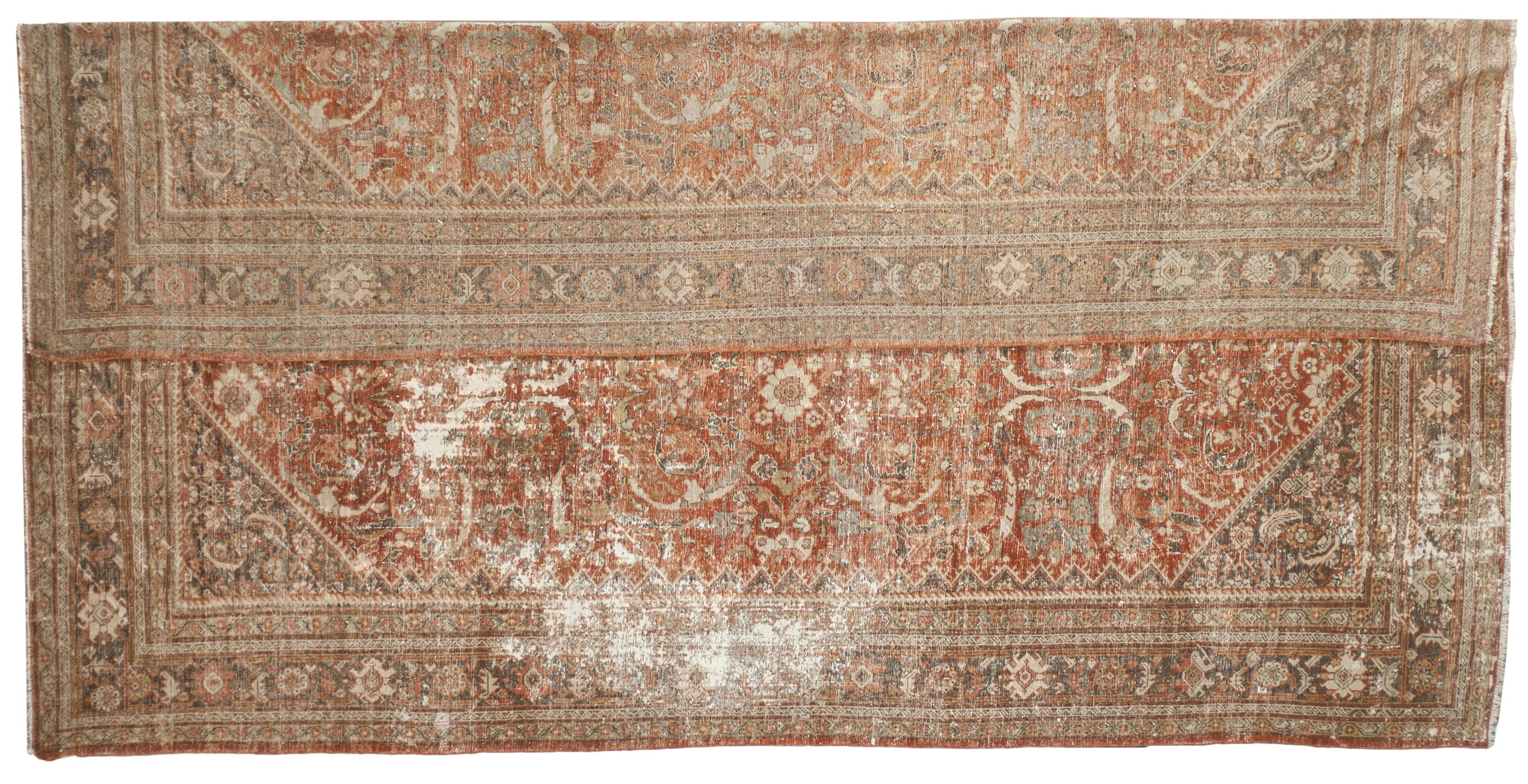 This Antique Distressed Mahal is an all wool Handmade and Hand knotted rug. It has an all over design from the 20th century and was made in Iran. The name is derived from the Mahallat village where the rugs were crafted, and they are characterized