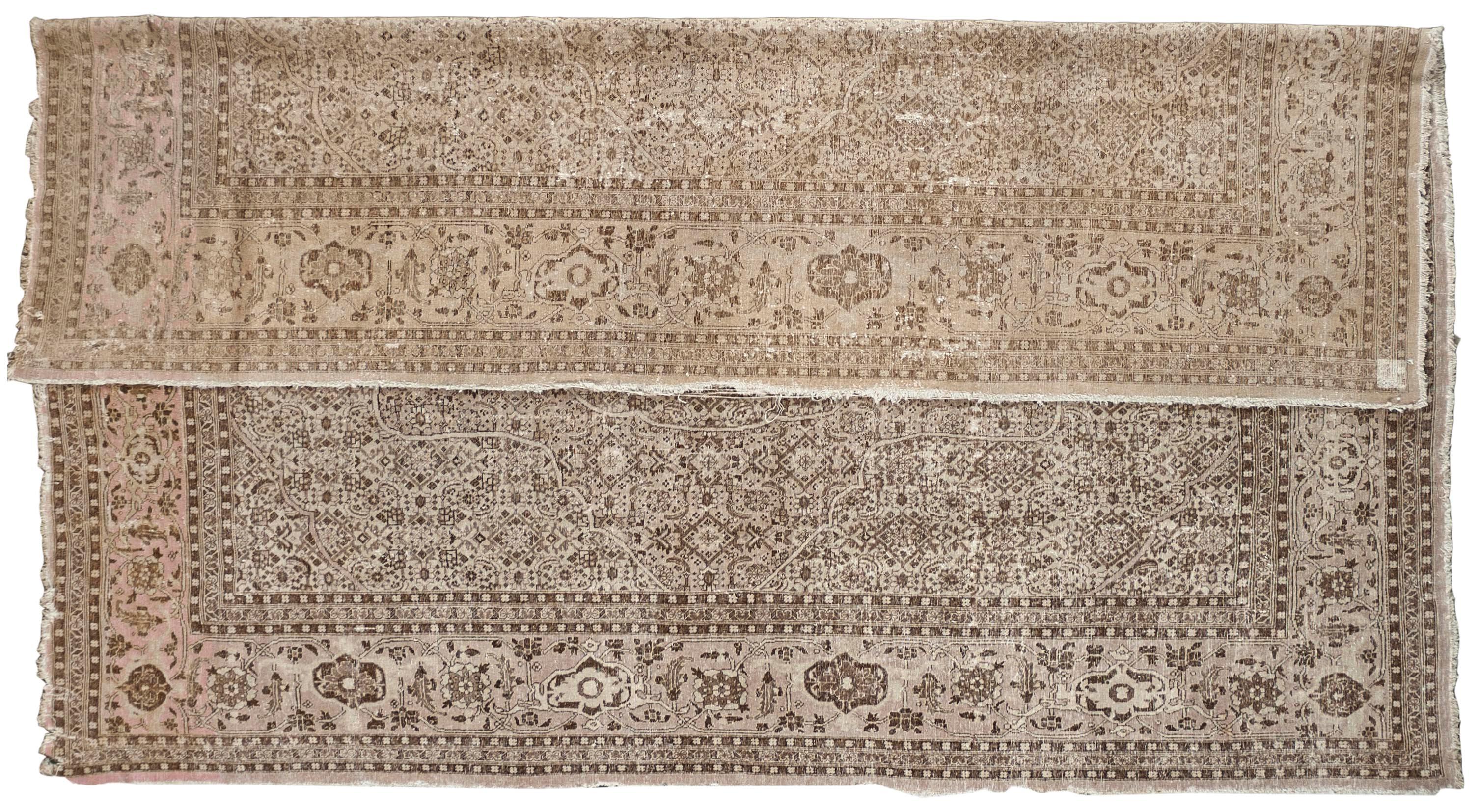 This Antique Distressed Mahal is an all wool Handmade and Hand knotted rug. This distinctive area rug that has a center medallion and wide stylized floral frame is from the 20th century and was made in Iran. The name is derived from the Mahallat