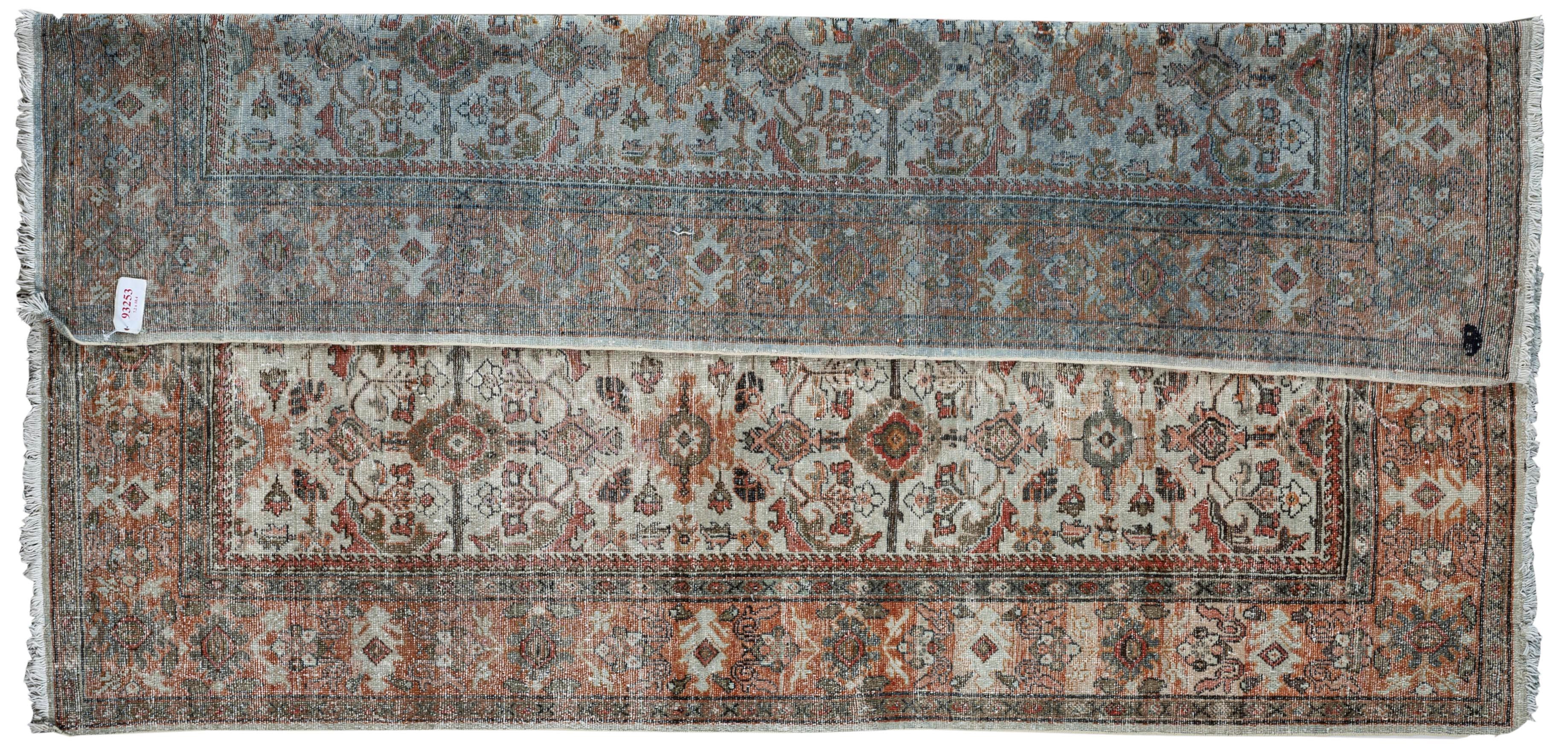 This antique distressed Mahal is an all wool Handmade and hand knotted rug. This distinctive area rug that has an all over design and wide stylized floral frame is from the 20th century and was made in Iran. The name is derived from the Mahallat