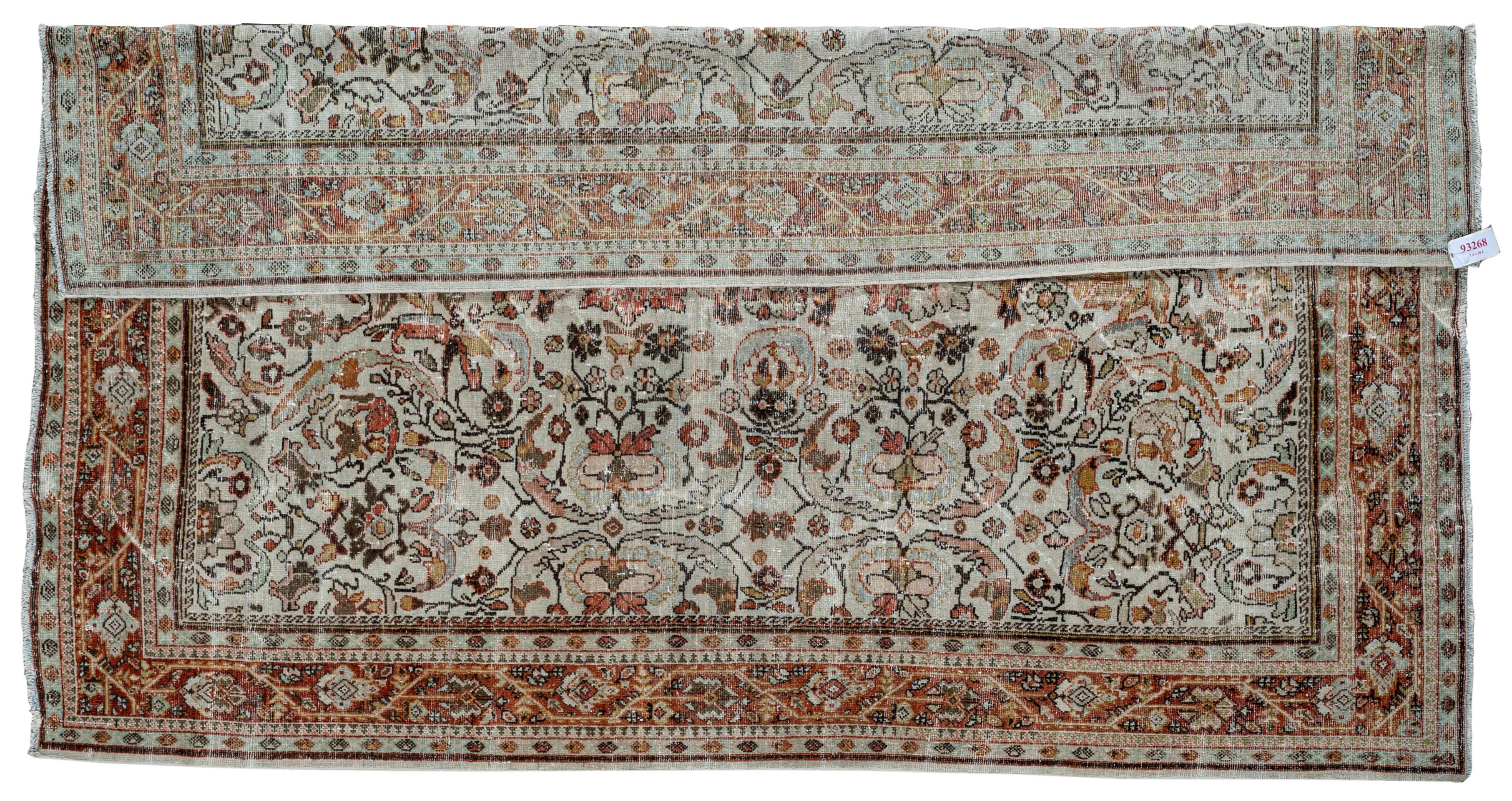 This antique distressed mahal is an all wool Handmade and Hand knotted rug. This distinctive area rug that has an all over design and wide stylized floral frame is from the 20th century and was made in Iran. The name is derived from the Mahallat