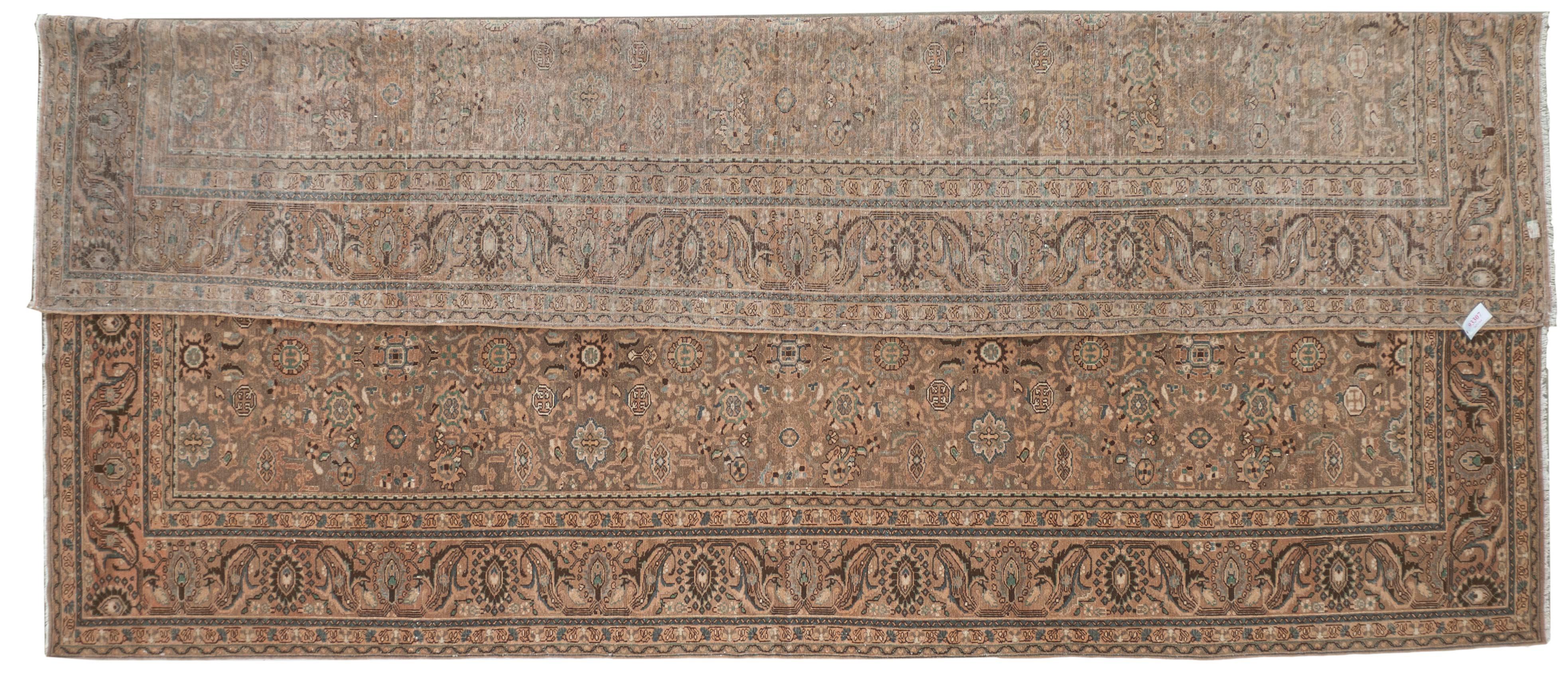 This Antique Distressed Mahal is an all wool Handmade and Hand knotted rug. This distinctive area rug that has an all over design and wide stylized floral frame is from the 20th century and was made in Iran. The name is derived from the Mahallat