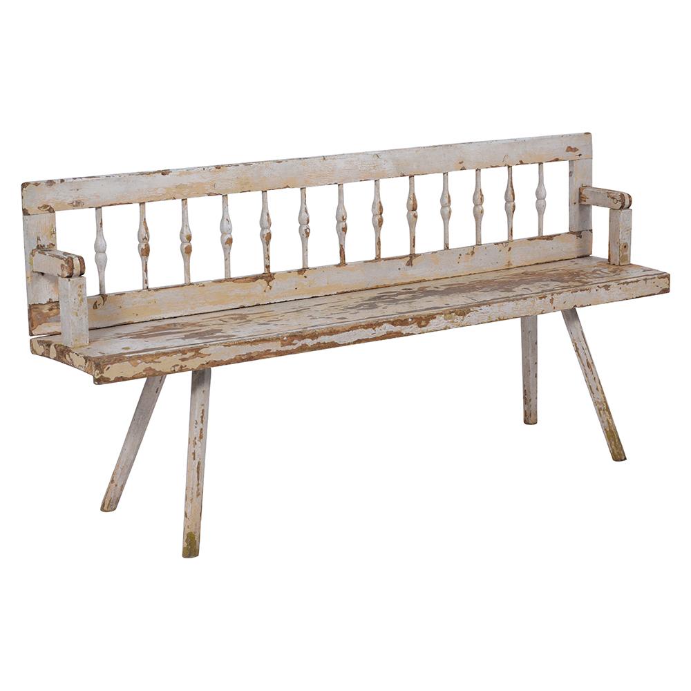 A fabulous antique Farm style bench crafted out of maple wood with eye-catching paint color with a unique distressed finish from age and use. This bench features a spindle backrest dovetailed armrests. This one of the kind Bench is raised by four