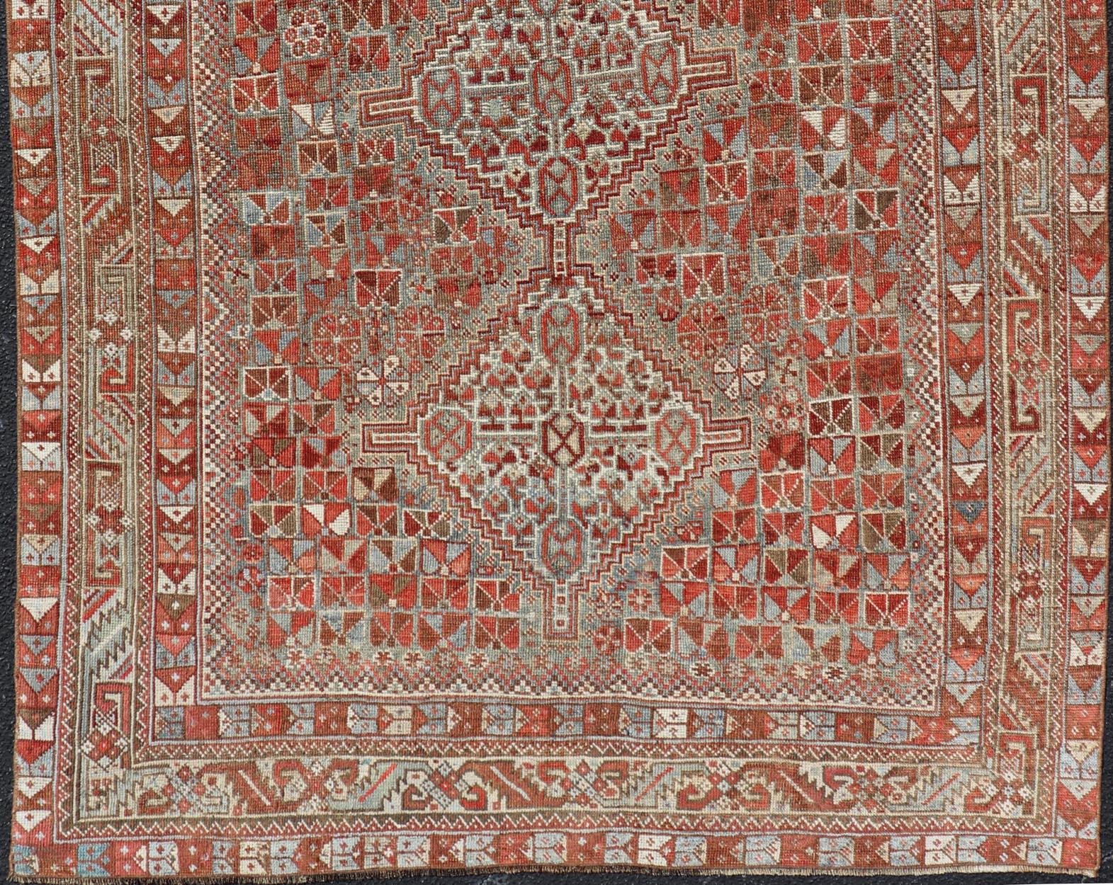 Antique Distressed Persian Medallion Shiraz Rug in Shades Rusty Red & Steel Blue In Good Condition For Sale In Atlanta, GA