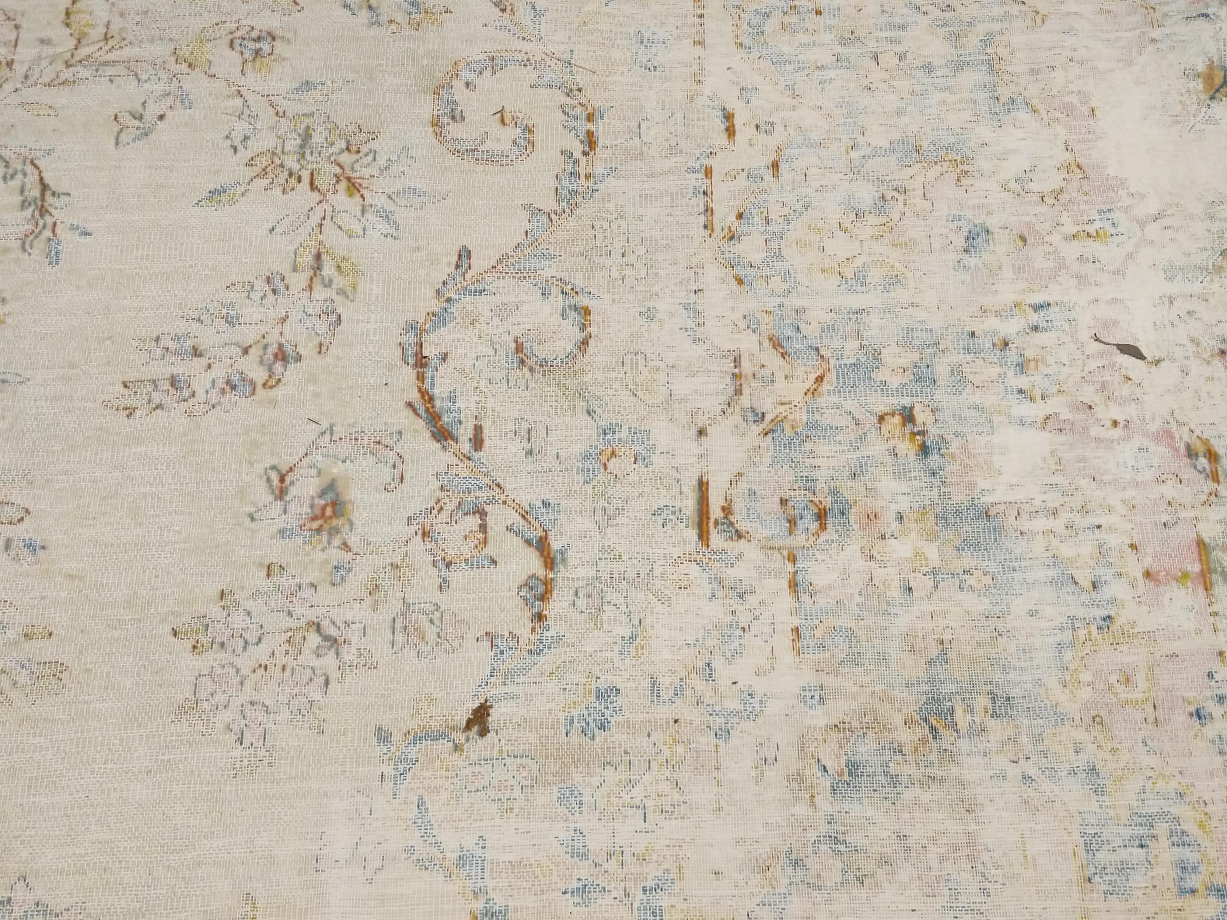 A highly refined room size carpet distinguished by a very soft palette and by an 'Old World' distressed condition, which imparts a certain understated elegance and a feeling as if the rug belonged forever to the room it decorates. Rugs of this type