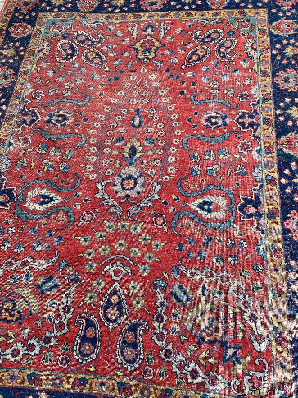 Nice late 19th century distressed rug with a beautiful floral design and nice natural colors with red, blue, yellow and pink, entirely hand knotted with wool velvet on cotton foundation.