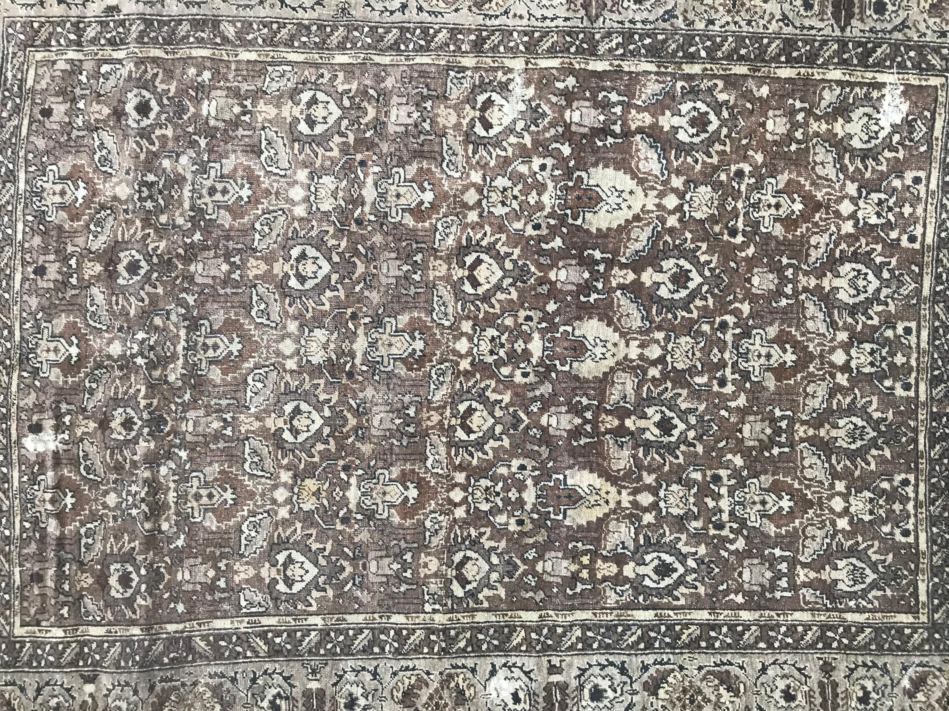 Early 20th century Turkish rug with Armenian scriptures at an extremity side and beautiful decorative design, with grey and brown colors, entirely hand knotted with wool velvet on wool foundation.