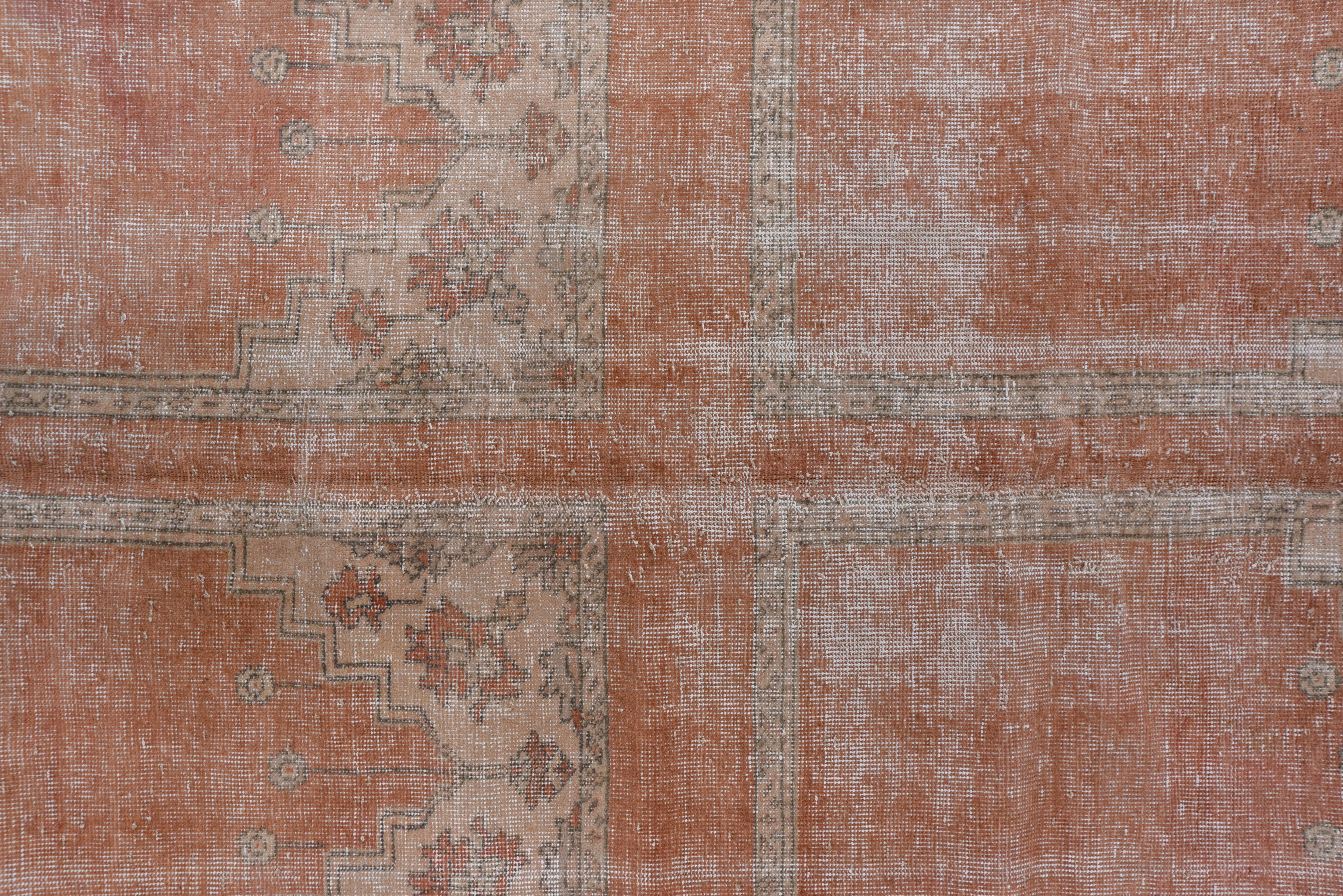 In a saph pattern of four rows of four plain pink niches under ivory spandrels. Saphs were woven in Oushak in large sizes for mosque prayer halls and this is a very rare example from the early 20th century, the wear/distress notwithstanding.