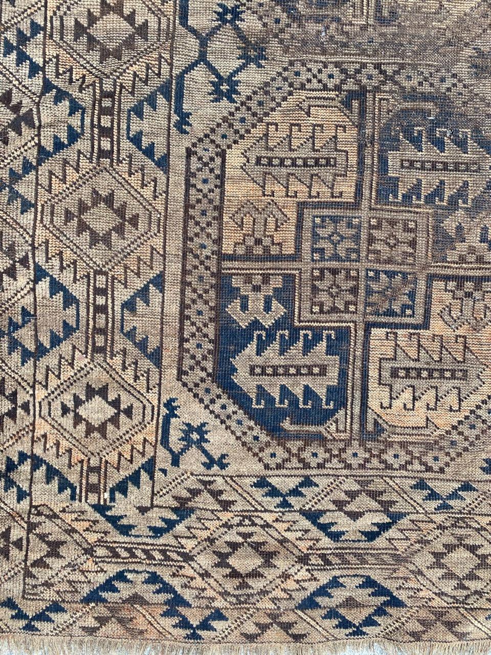 Distressed antique Turkmen Afghan rug with geometrical design and nice grey colors, entirely hand knotted with wool velvet on wool foundation.