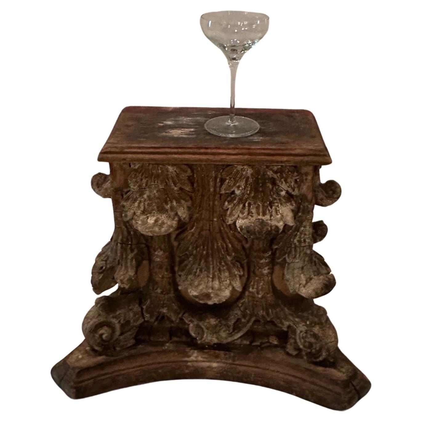 One of a kind antique carved distressed wooden fragment from a Corinthian column, salvaged and functional as a character rich architectural end table.