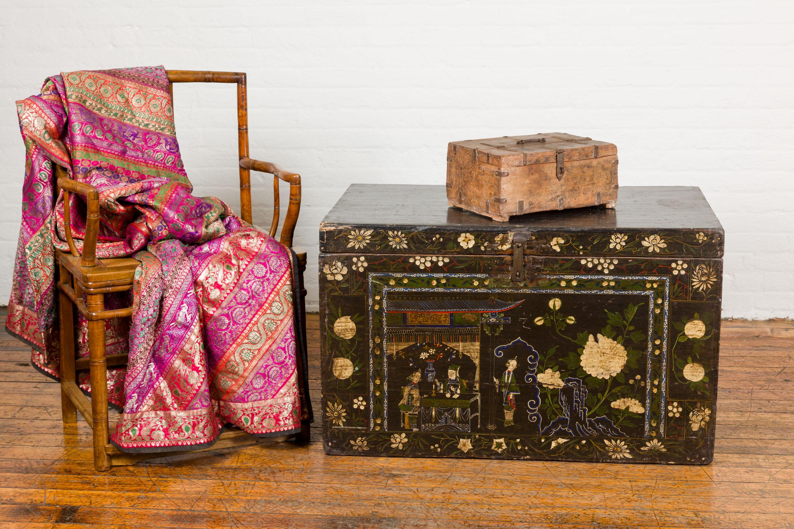 An Indian wooden document box from the 19th century with incised concentric circle motifs, metal braces and partial opening top. Discover the charm of history with this exquisite 19th-century Indian wooden document box, a statement piece that