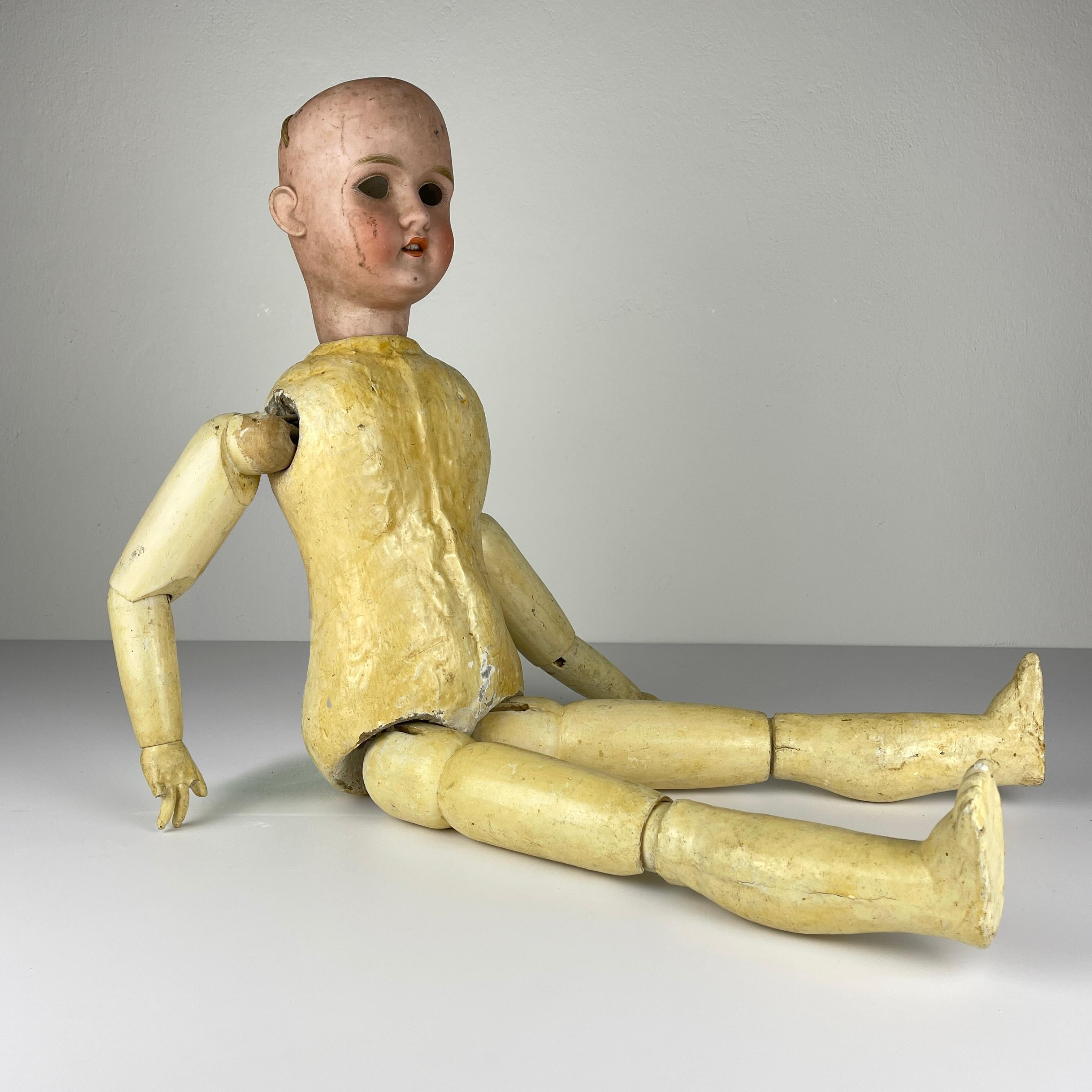 An antique Austrian doll Plass & Roesner, Roma 1913, is an infrequent visitor to the doll market.
As you can see in the photos, her fingertips are partially missing. She needs a good house and proper restoration. The head is made of porcelain, the