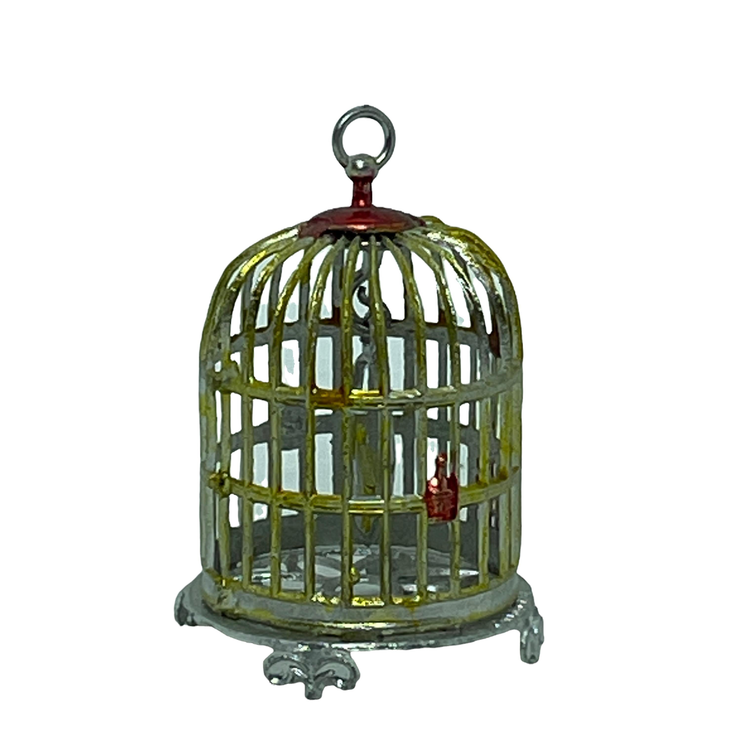 An outstanding bird cage in painted soft metal with a colorful Bird. To hang in your dollhouse or to put on a table in a salon or a parlor.
Made of pewter. Nice for every decoration in your dollhouse. 
It is in very good condition with no chips