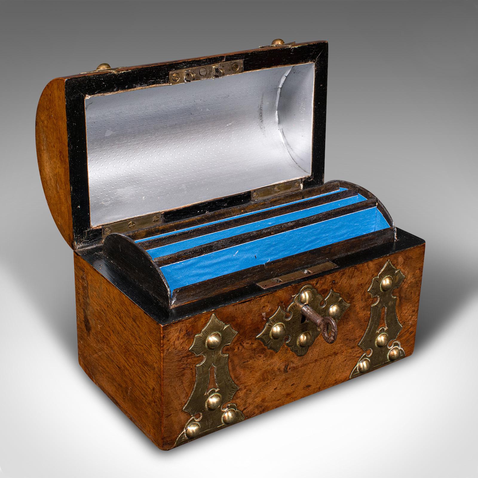 This is an antique dome top calling card box. An English, walnut and brass bound desktop tidy, dating to the early Victorian period, circa 1850.
 
Bold form and delightful brightwork to this neat stationery box
Displays a desirable aged patina