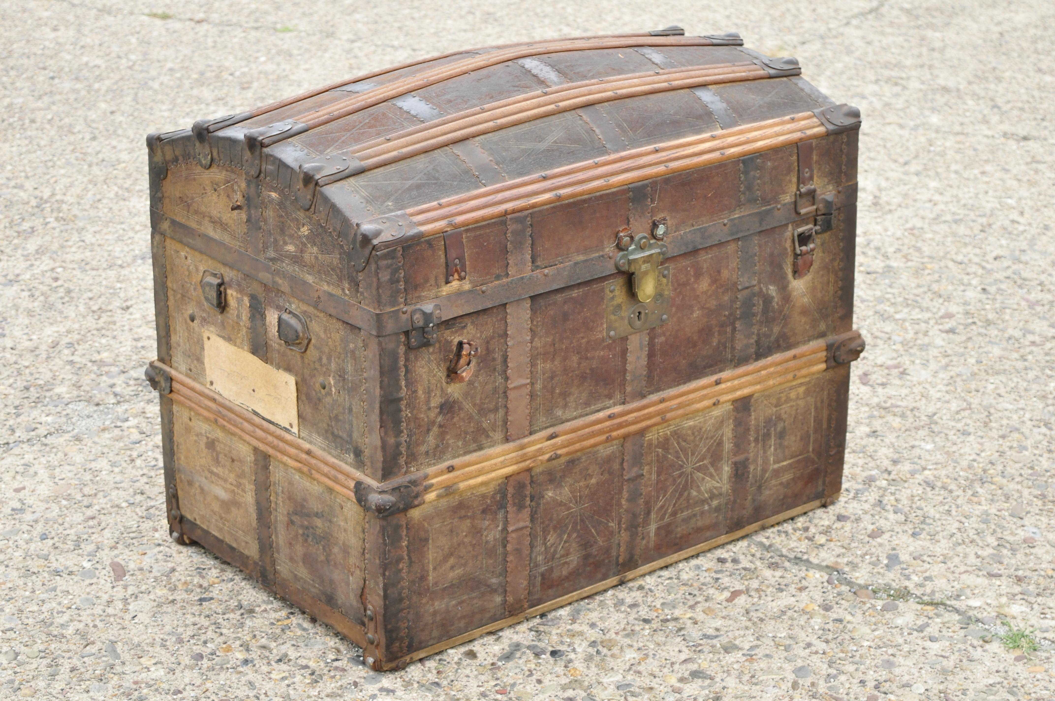 Antique dome top wood leather metal distressed pirates treasure chest trunk. Item features rolling casters, oak wood bands, fitted interior, embossed leather case, very nice antique item, quality craftsmanship, great style and form.