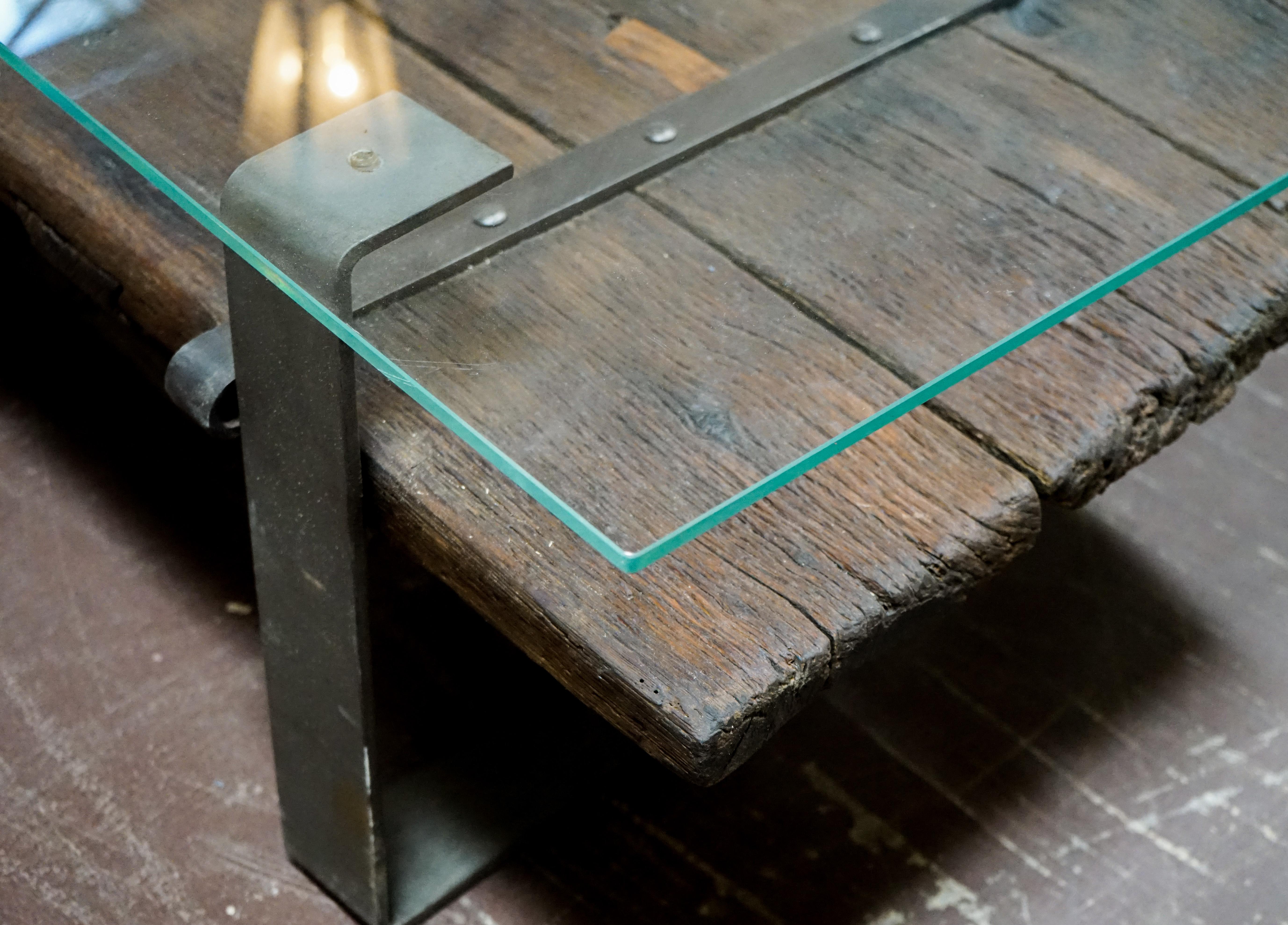 This modern coffee table mixes old and new: an antique door from the 19th century is set to an iron base and shielded with a glass rectangular top. The door acts as a useful shelf for books or items to display, or as a conversation piece of its own.