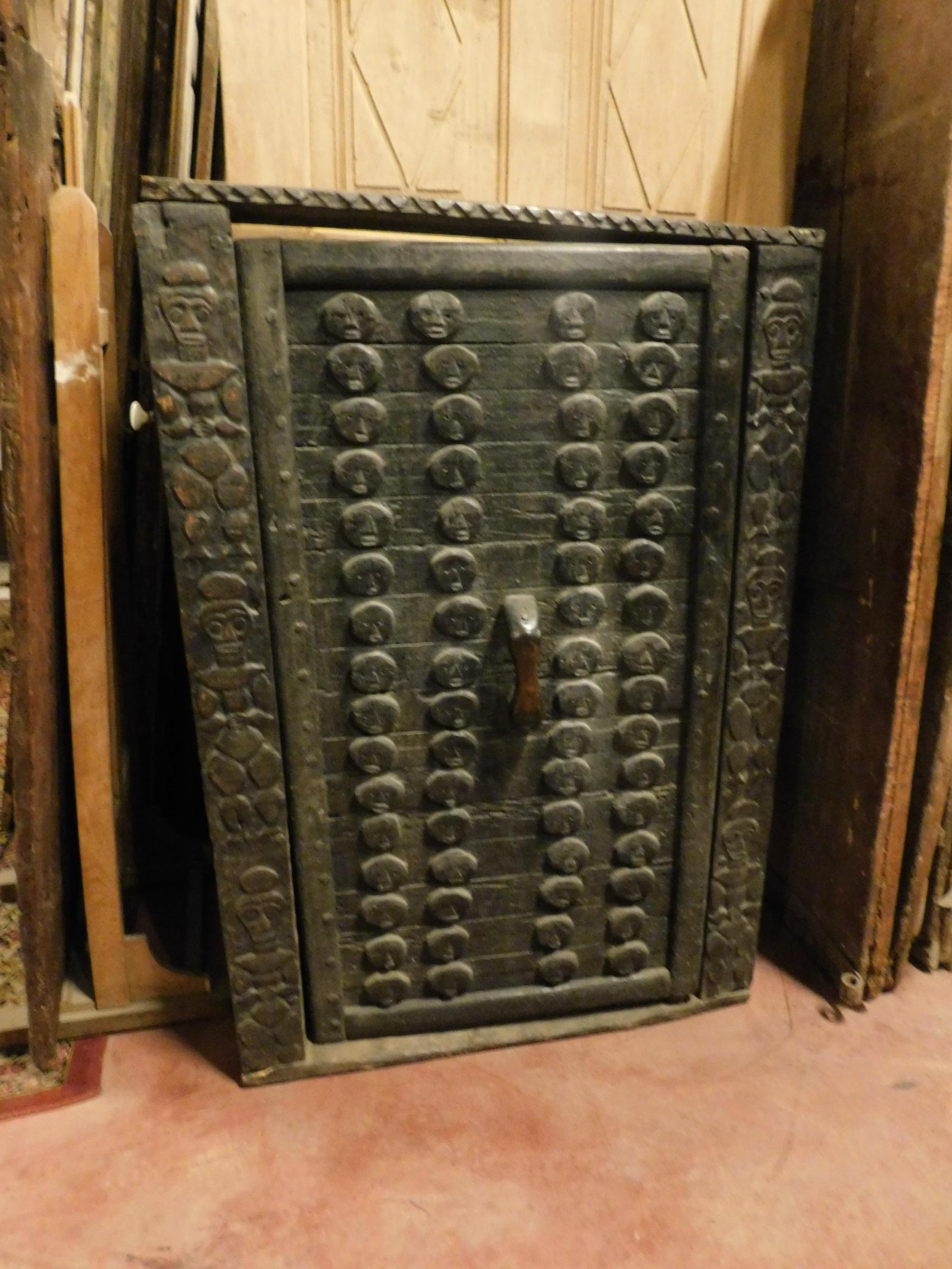 Antique door dark wood brown African of the Dagon, with frame carved with images of outdated enemies to become chief, small because of the subjects to bow to enter his house, very special and rare in wood dark.