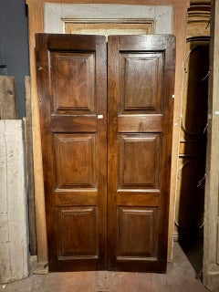 Antique door in walnut wood, two leaves with carved panels, Italy