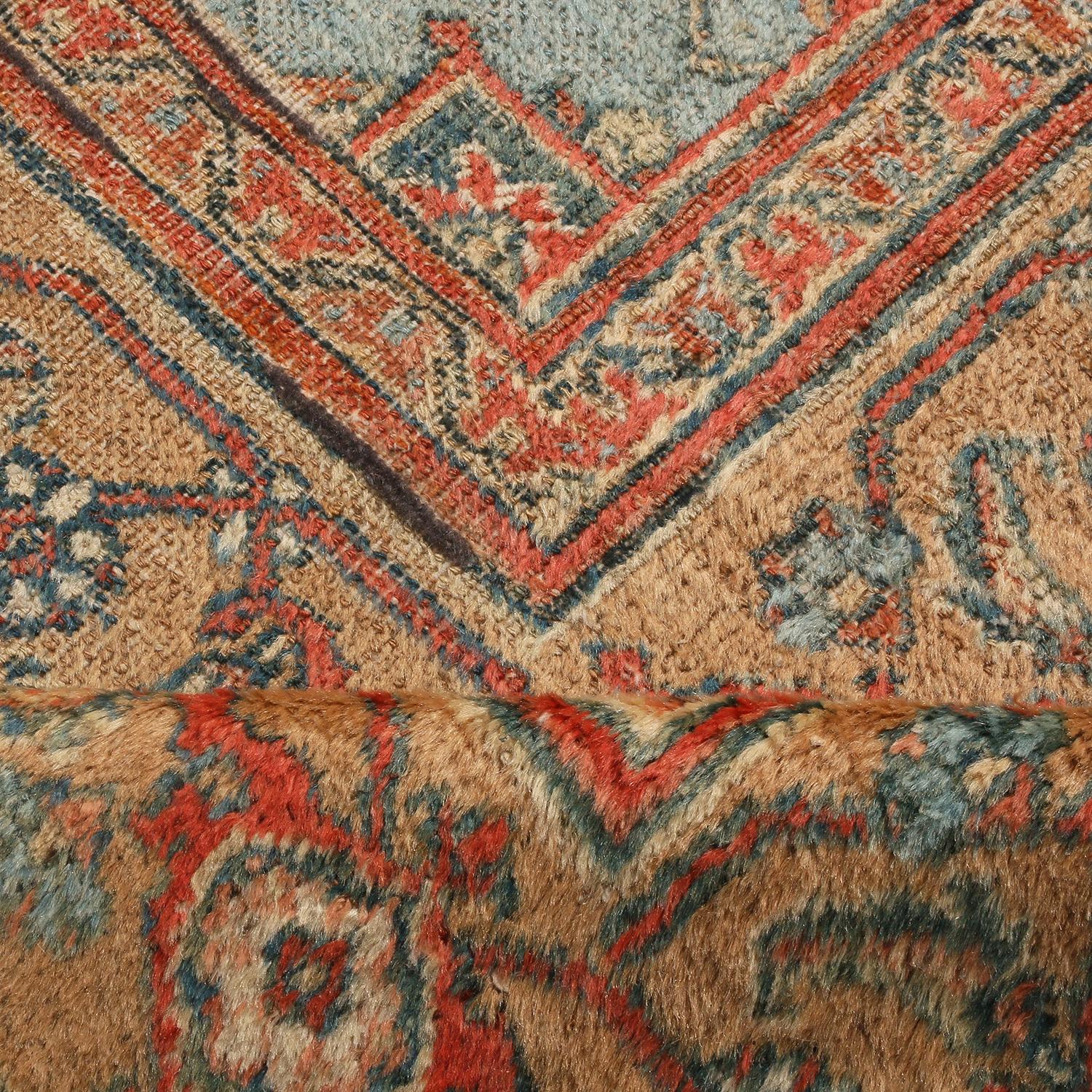 Hand knotted in Persia originating between 1870-1880, this antique floral Doroksh rug marries a unique colorway with a celebrated traditional pattern known as the Herati, or “fish” pattern seen dancing in the field and border alike. The variations