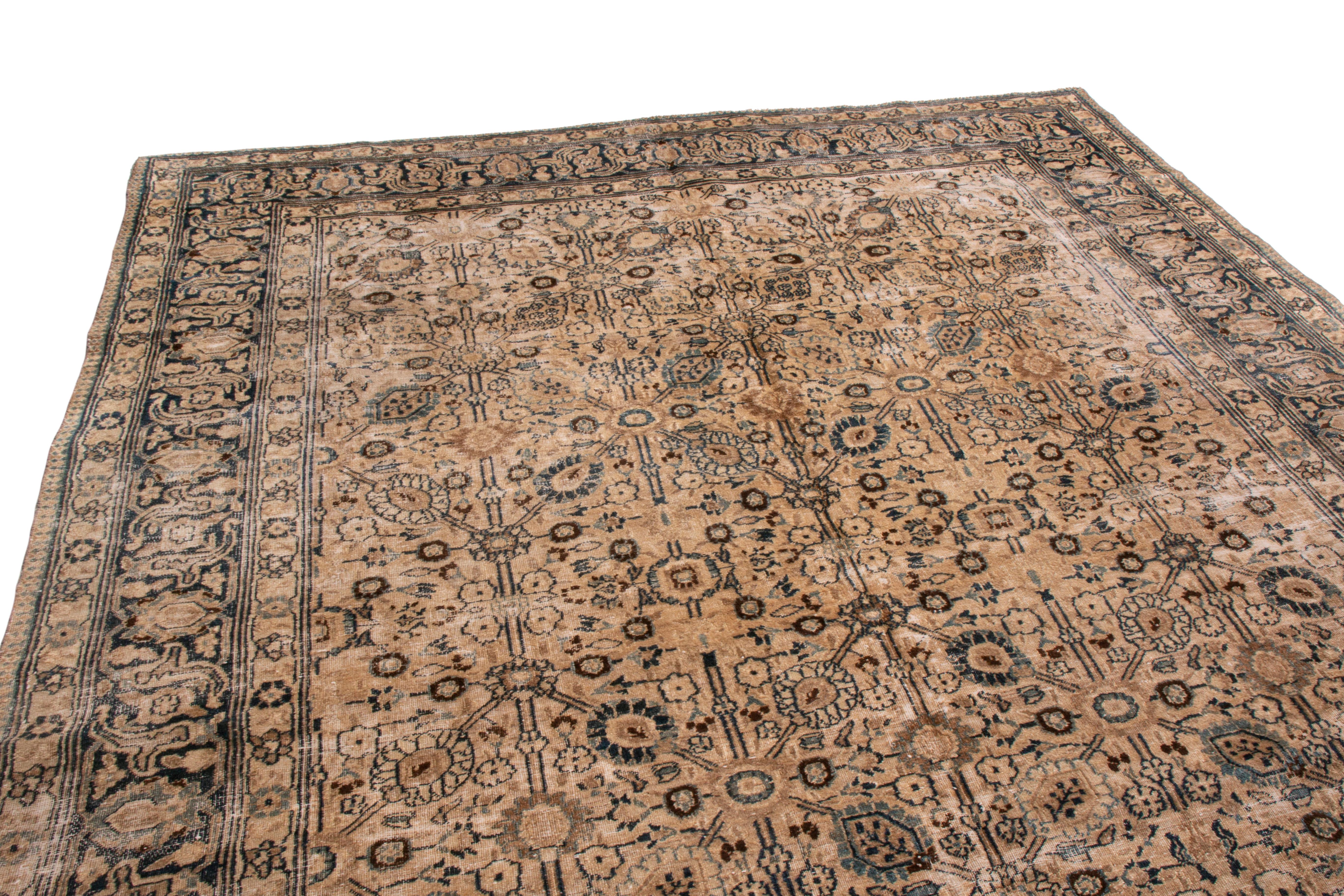 This antique Doroksh transitional wool rug is from Persia in 1910. The border has a highly stylized garland and vine scroll pattern—idyllic of Persian rugs—though the field’s geometric-floral design is more transitional with minor modern influences