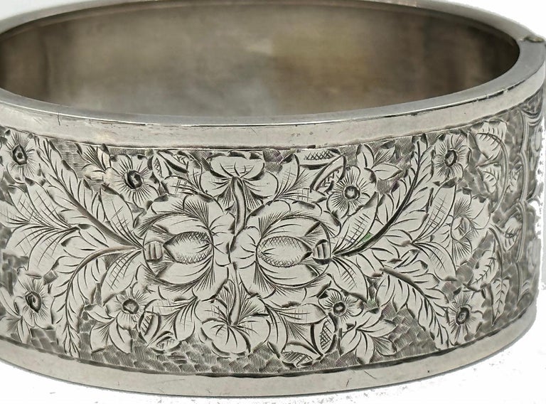 Leaves and flowers completely fill the front of this Victorian silver cuff bangle bracelet.  Dating to the 1880’s, this silver bangle was produced in England during the height of their jewelry production.  Queen Victoria was keen on industry and