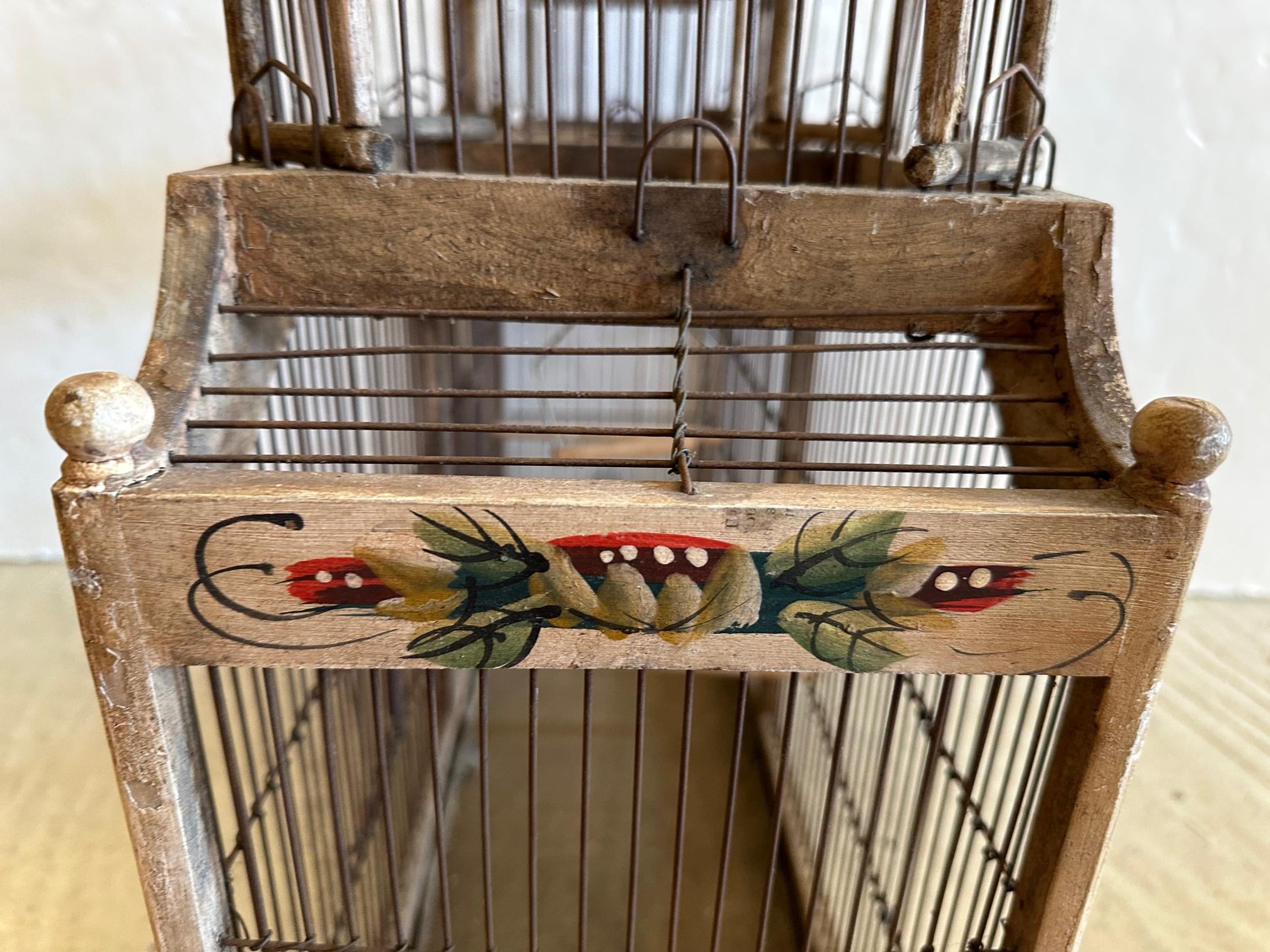Beautiful old painted wood double domed bird cage having 4 spring doors.